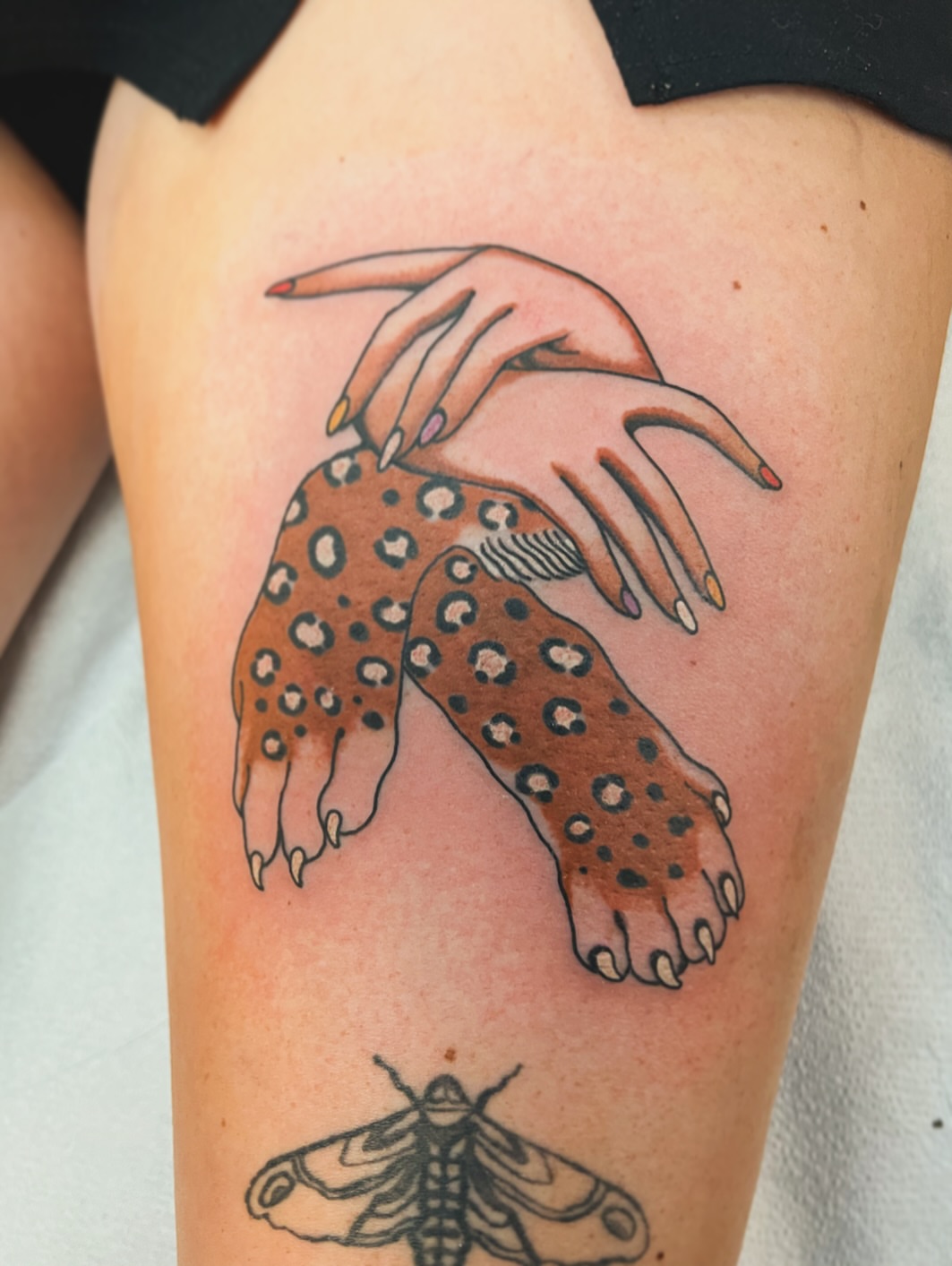 Hand and leopard print dotwork tattoo on the thigh by superteal