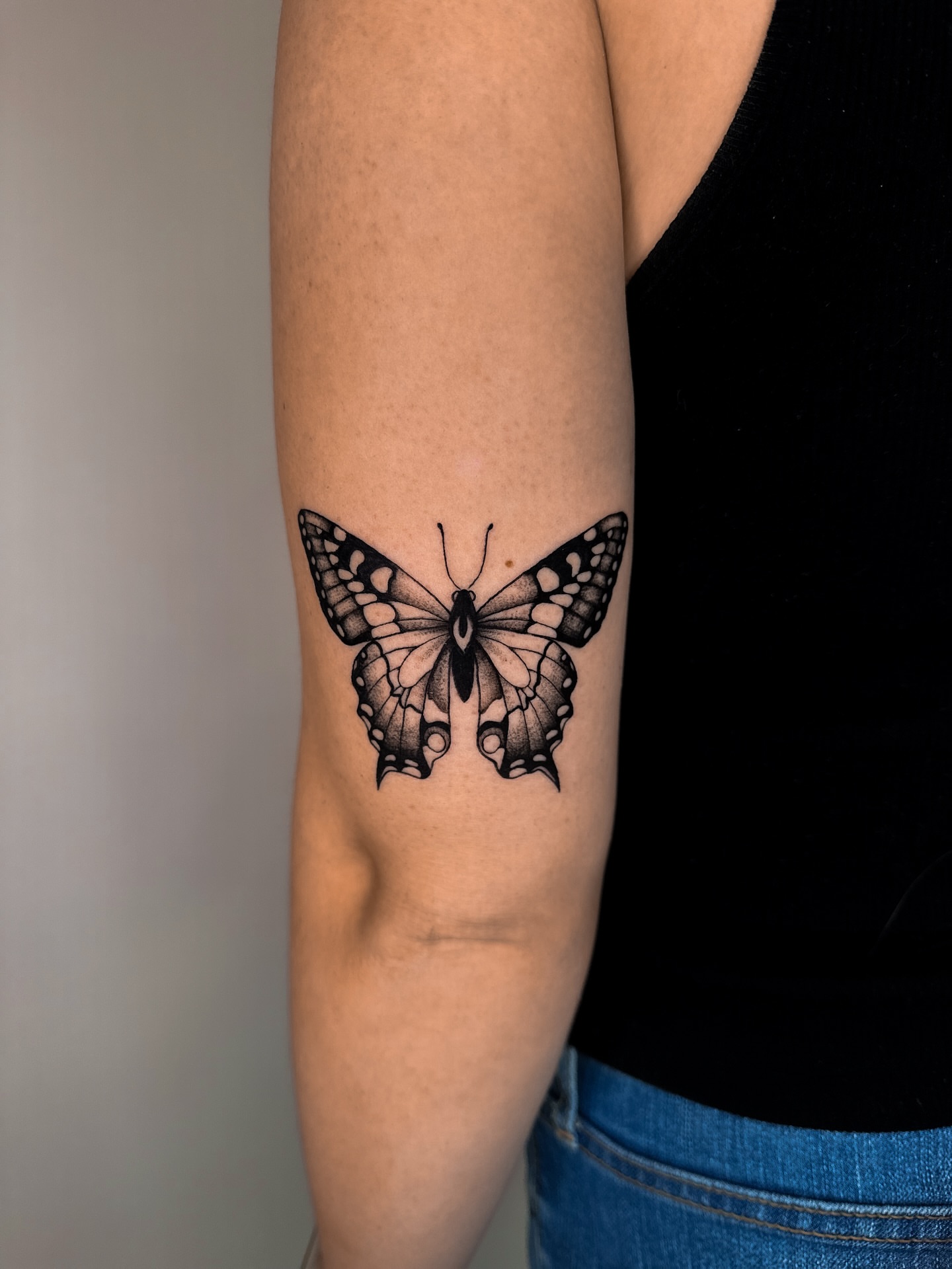 Butterfly black and grey tattoo on the forearm by Lauren