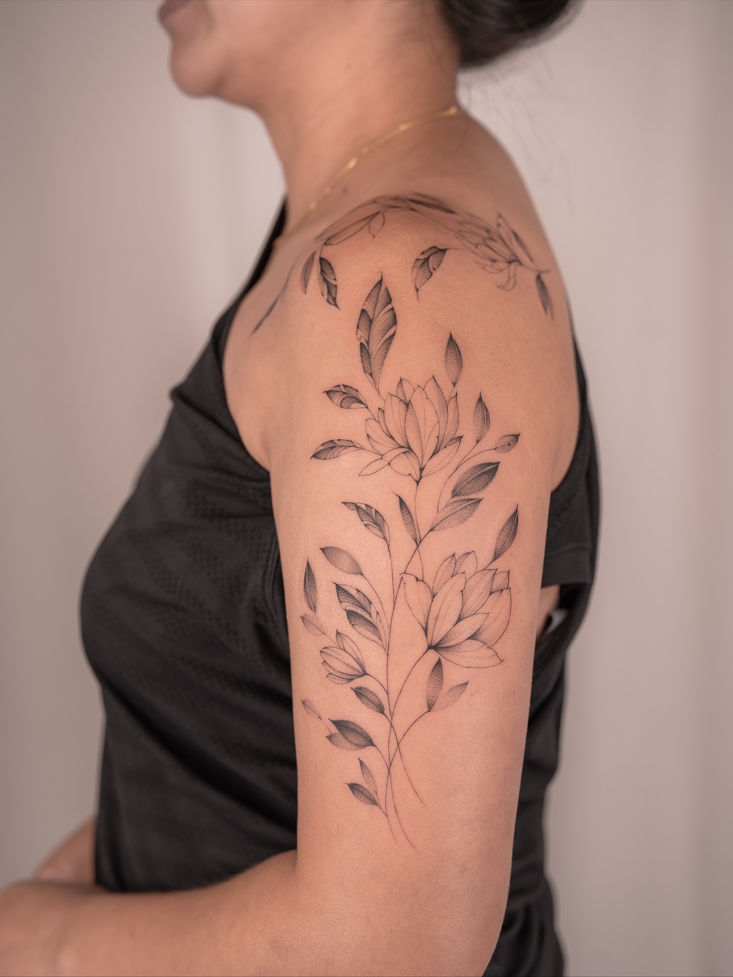 Lotus flower black and grey tattoo on the shoulder by Leo Gao