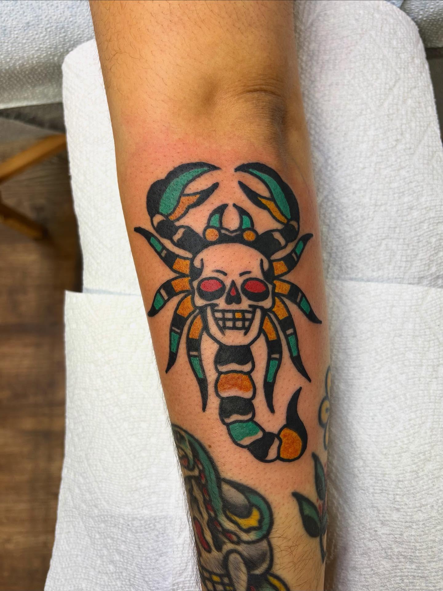 Skull with headdress American traditional tattoo on the forearm by Dave