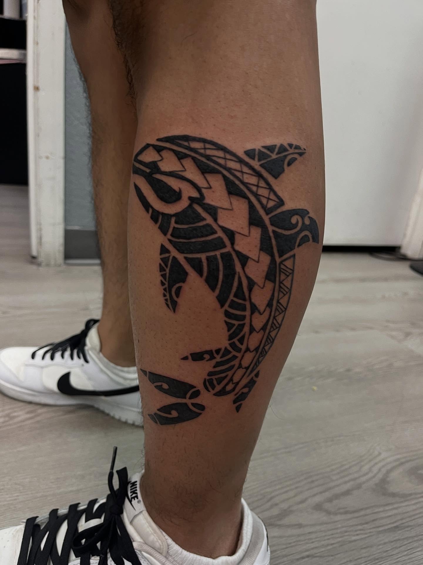 Dolphin tribal tattoo on the calf by Kevin, Las Vegas, Nevada