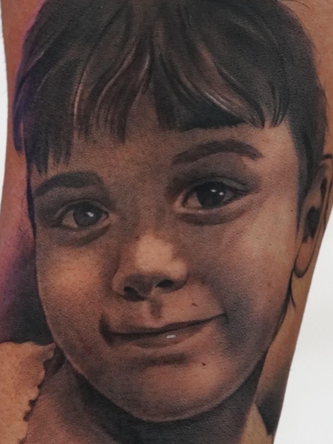 Child portrait realism tattoo on the forearm by Luis Rodriguez