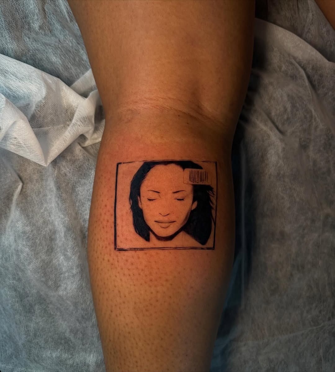 Portrait with barcode surrealism tattoo on the forearm by sanjai