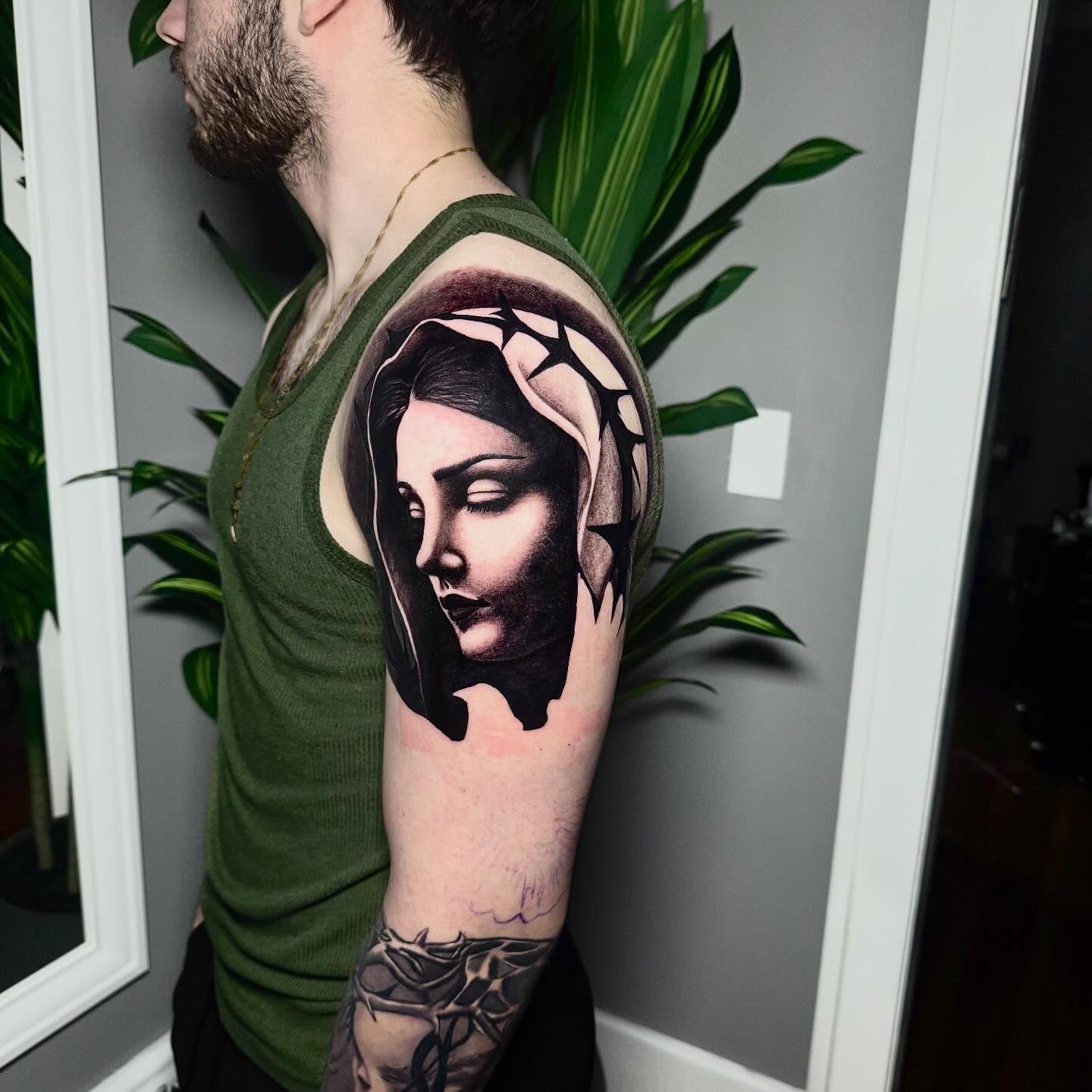 Religious figure realism tattoo on the forearm by caleb coley