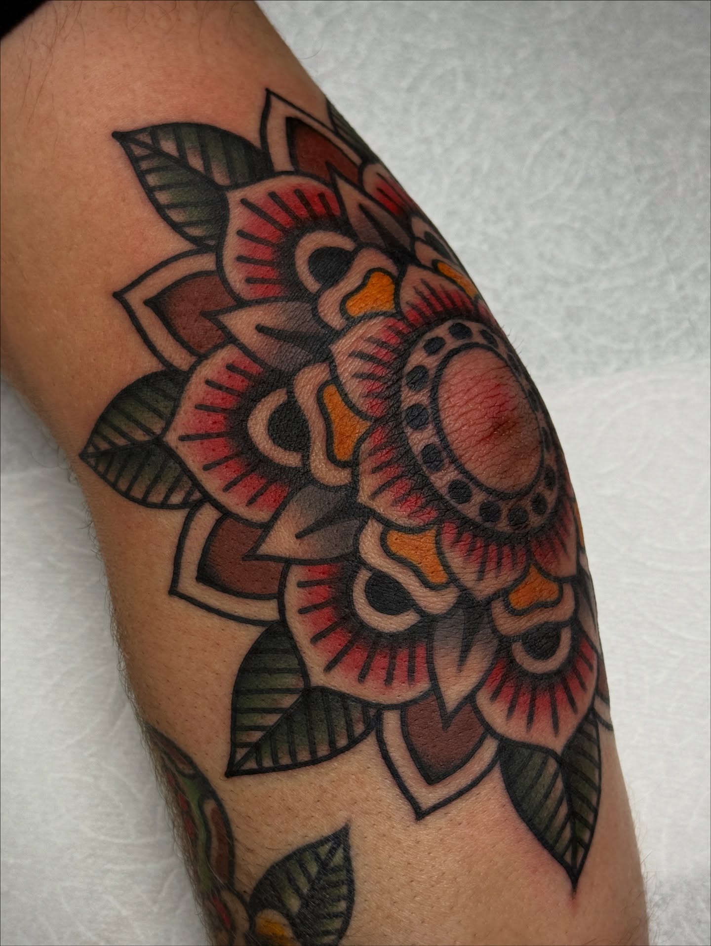 Floral bouquet American traditional tattoo on the forearm by Jordan Allen