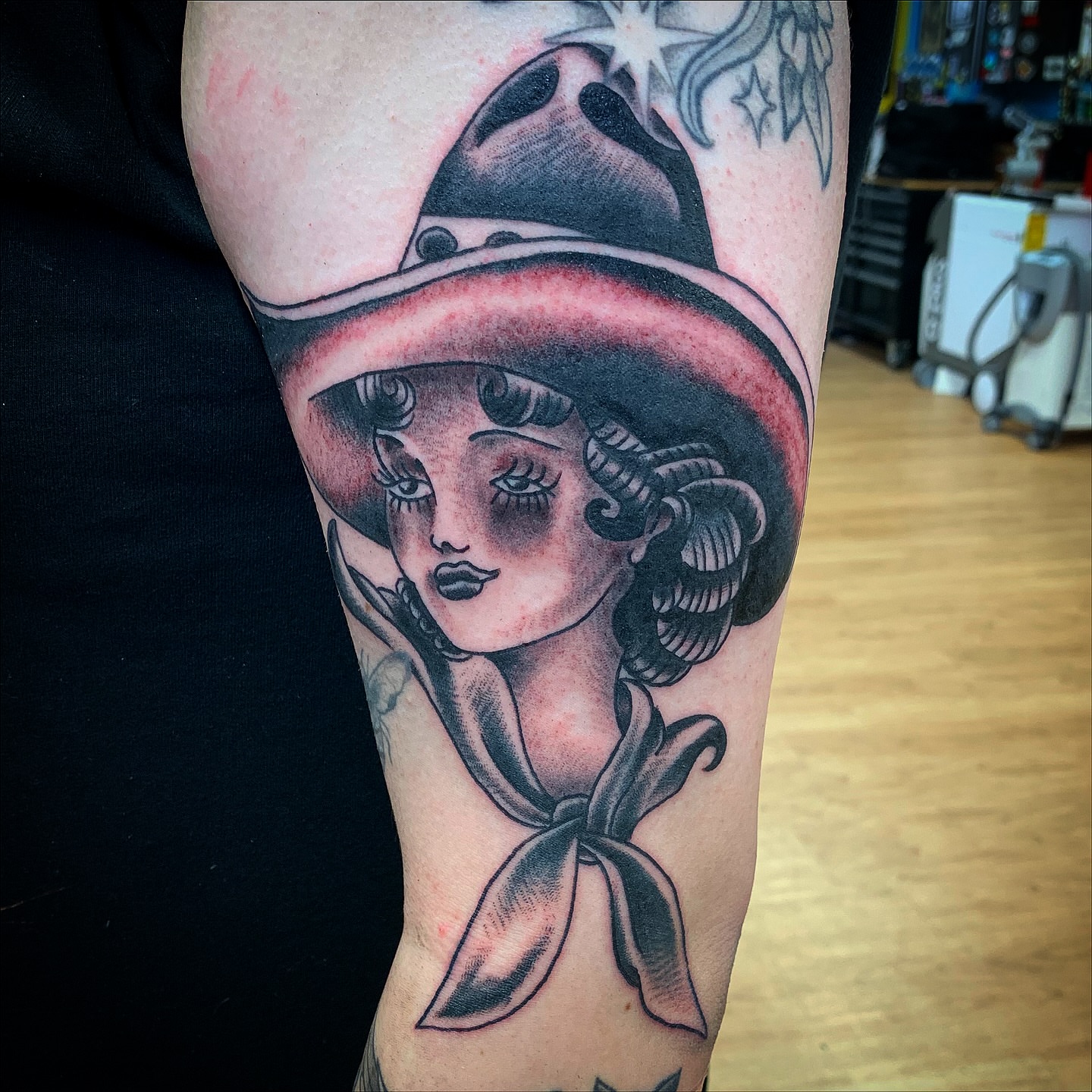 Woman wearing hat American traditional tattoo on the forearm by Tattoos Las Vegas,NV