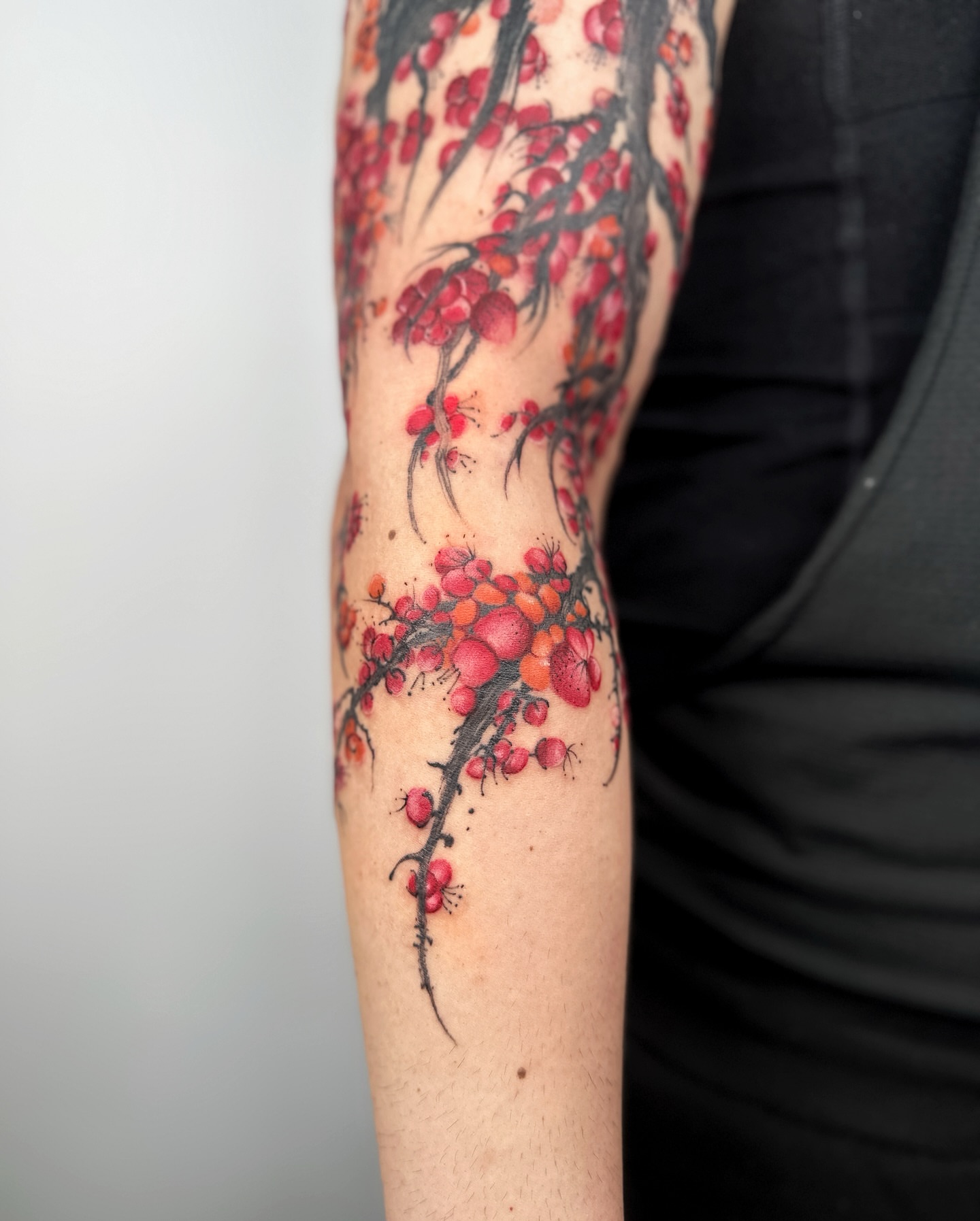 Cherry blossoms realism tattoo on the forearm by Jiang_Tattooer