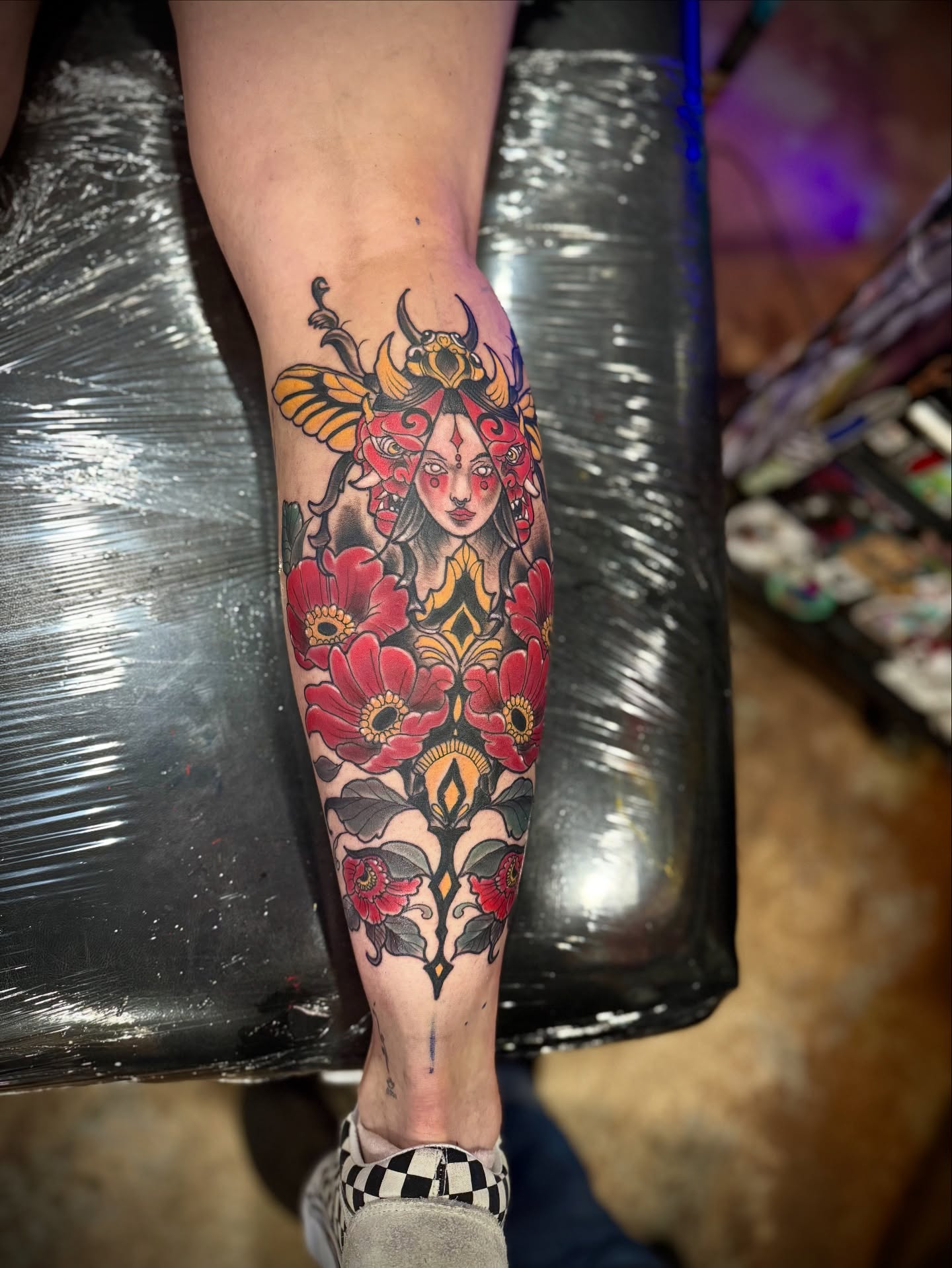 Woman with flowers American traditional tattoo on the forearm by David C. McGhee
