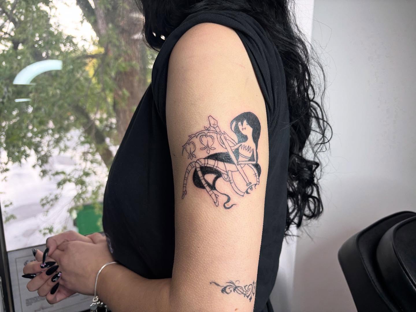Woman riding horse anime tattoo on the upper arm by Mickey