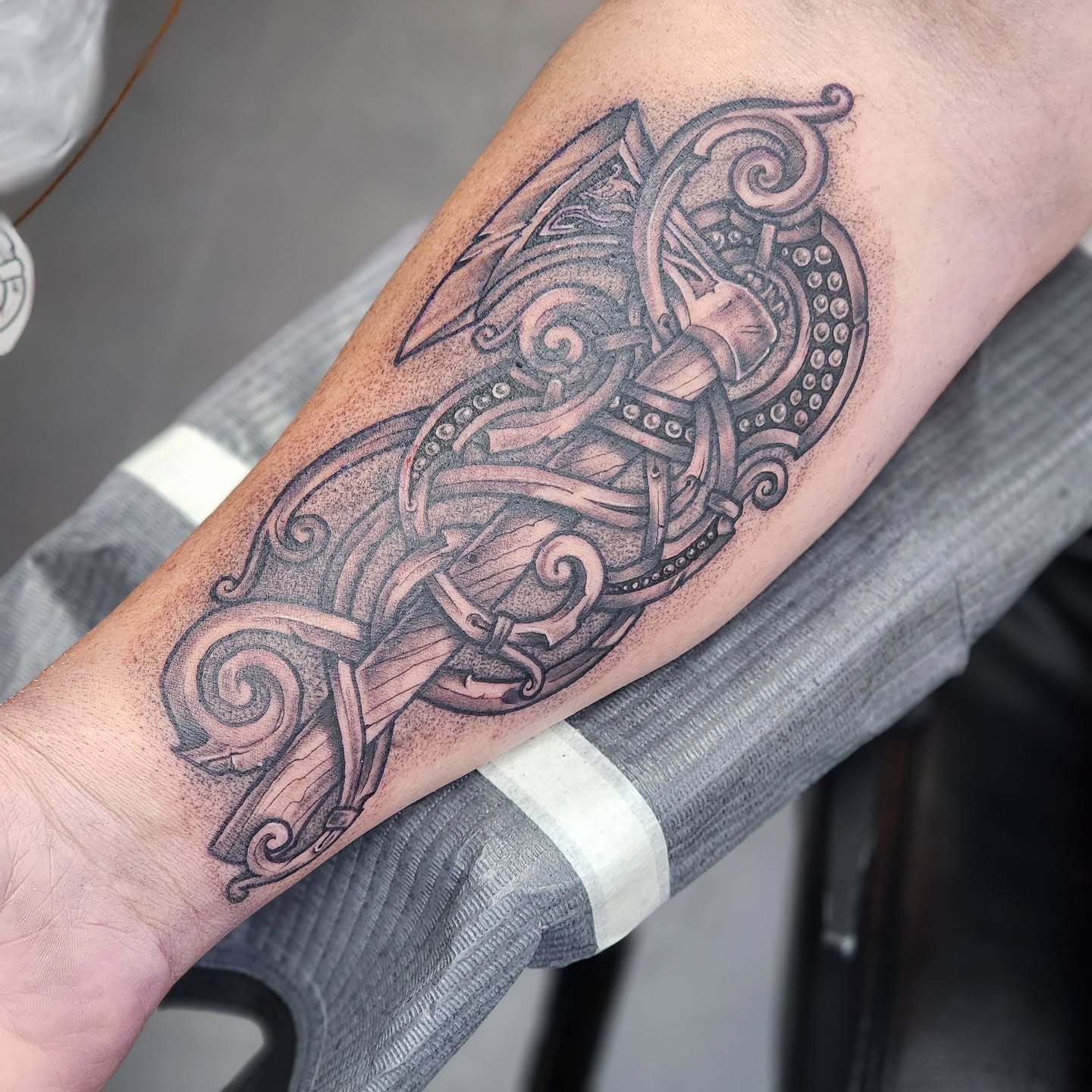 Viking axe geometric tattoo on the forearm by Robert Glover