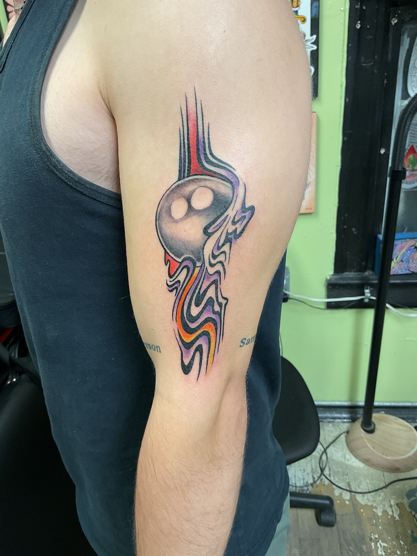 Bowling ball new school tattoo on the upper arm by Roachrude