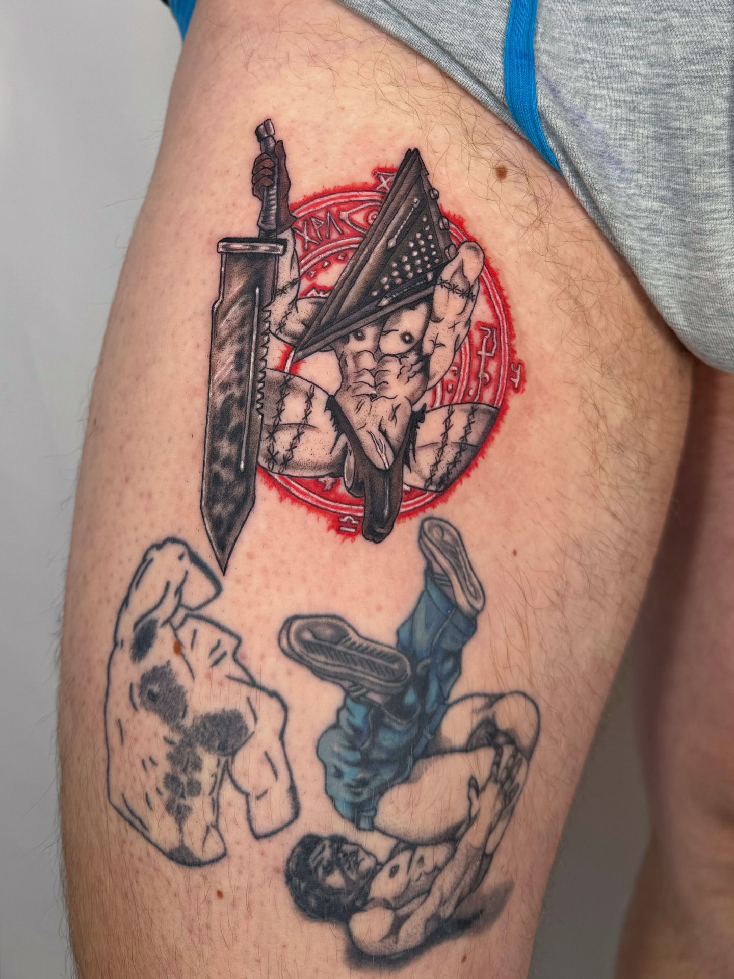 American flag, knife, hands, mannequin American traditional tattoo on the thigh by Franky A Bonifacio, Seattle, Washington