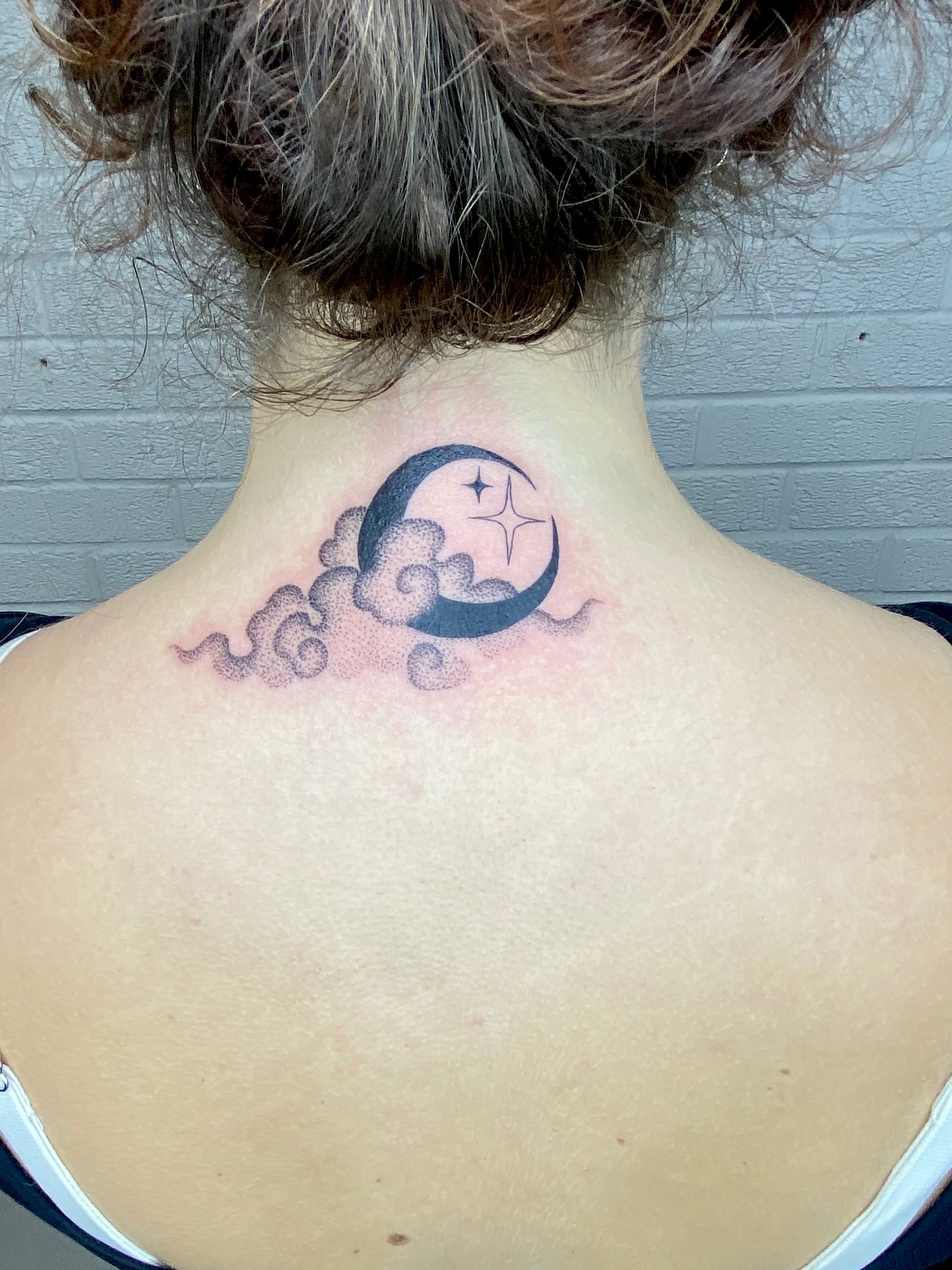 Moon and stars dotwork tattoo on the neck by Ellena Reggiani