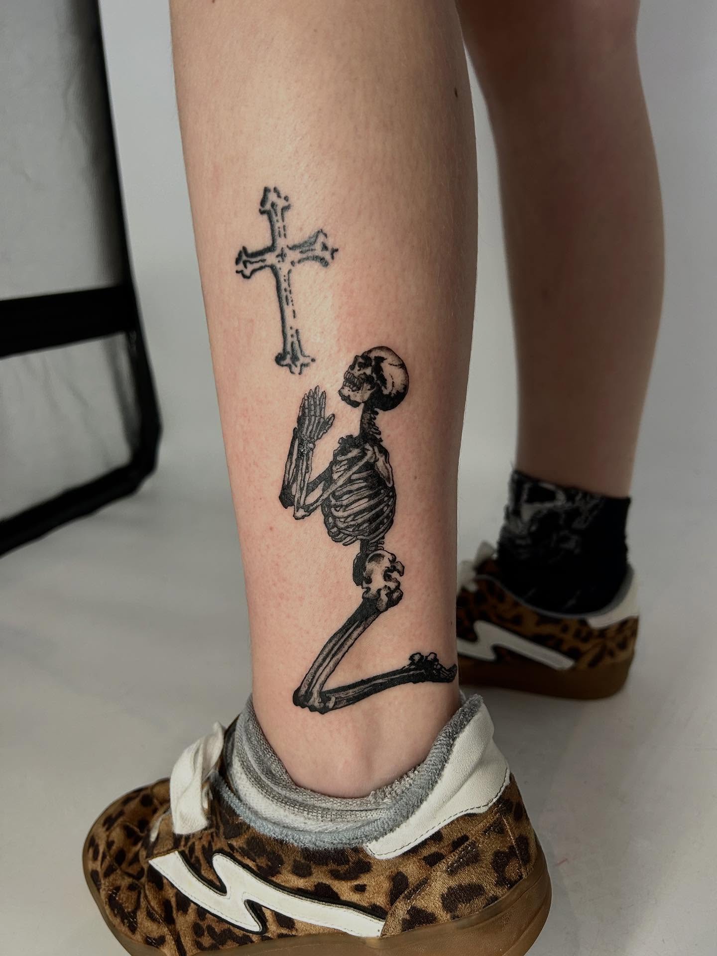 Praying skeleton black and grey tattoo on the calf by Lip™