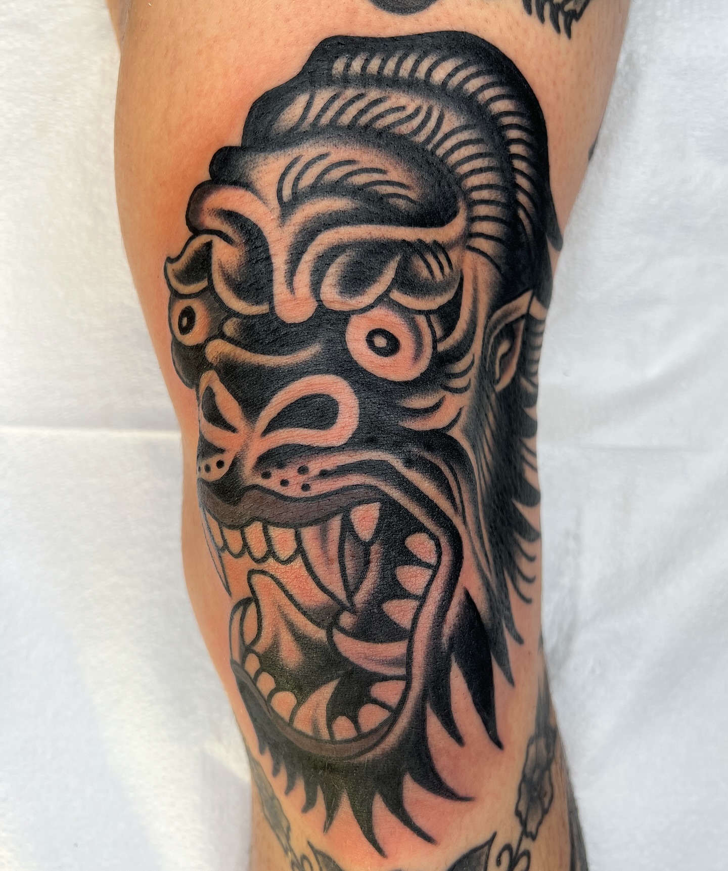 Demon head American traditional tattoo on the forearm by Nick Judkins Tattoo