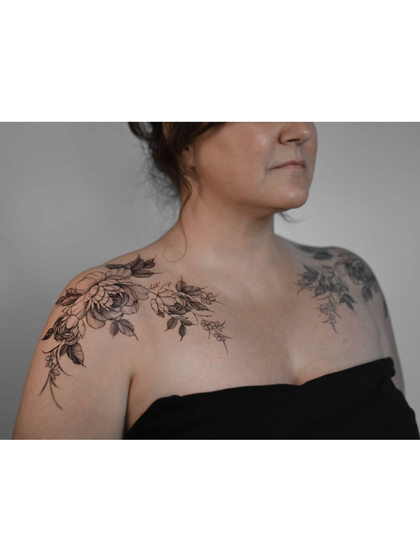 Floral bouquet black and grey tattoo on the shoulder by Anastasiia