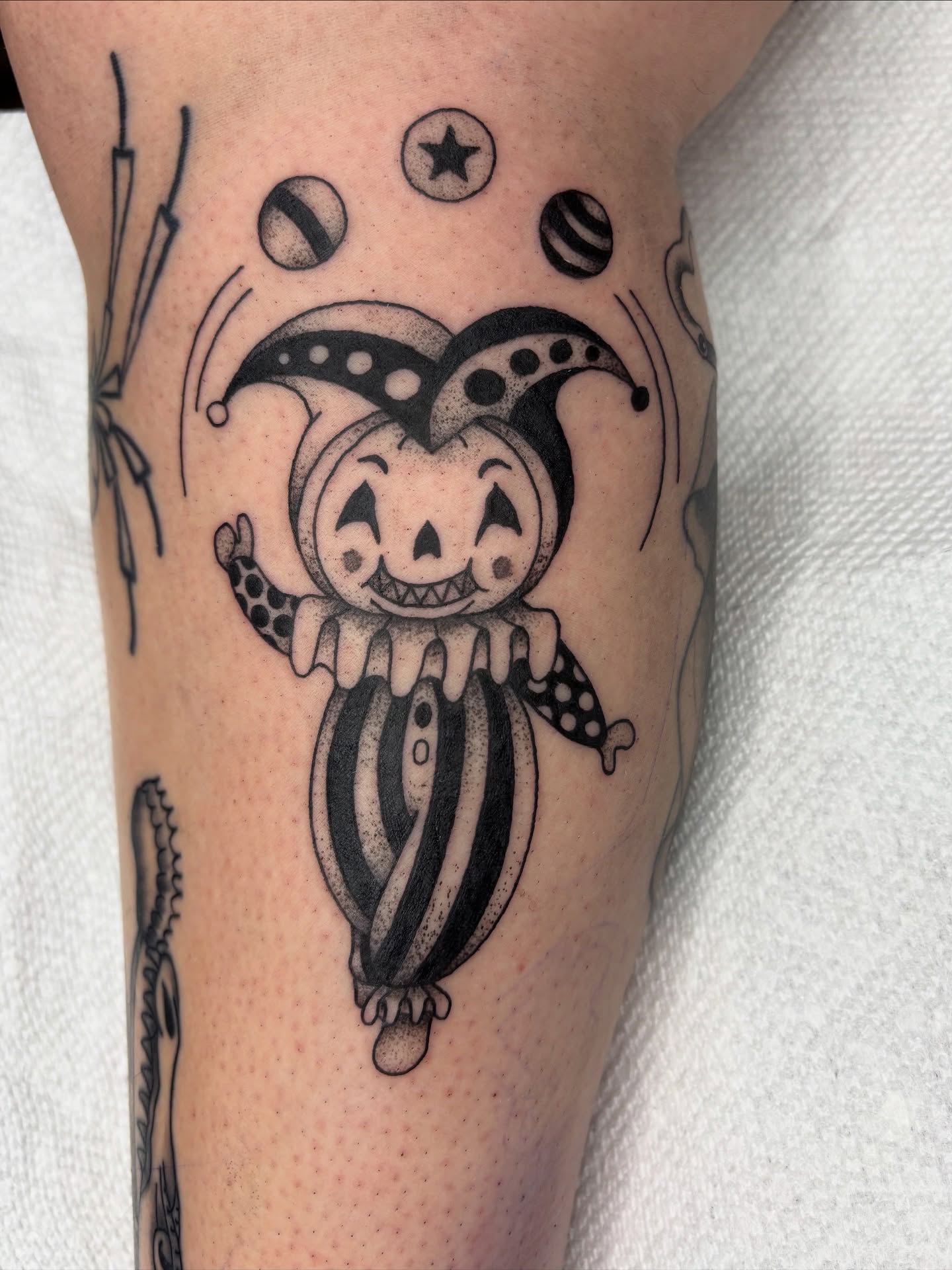 Clown jester black and grey tattoo on the forearm by kylie