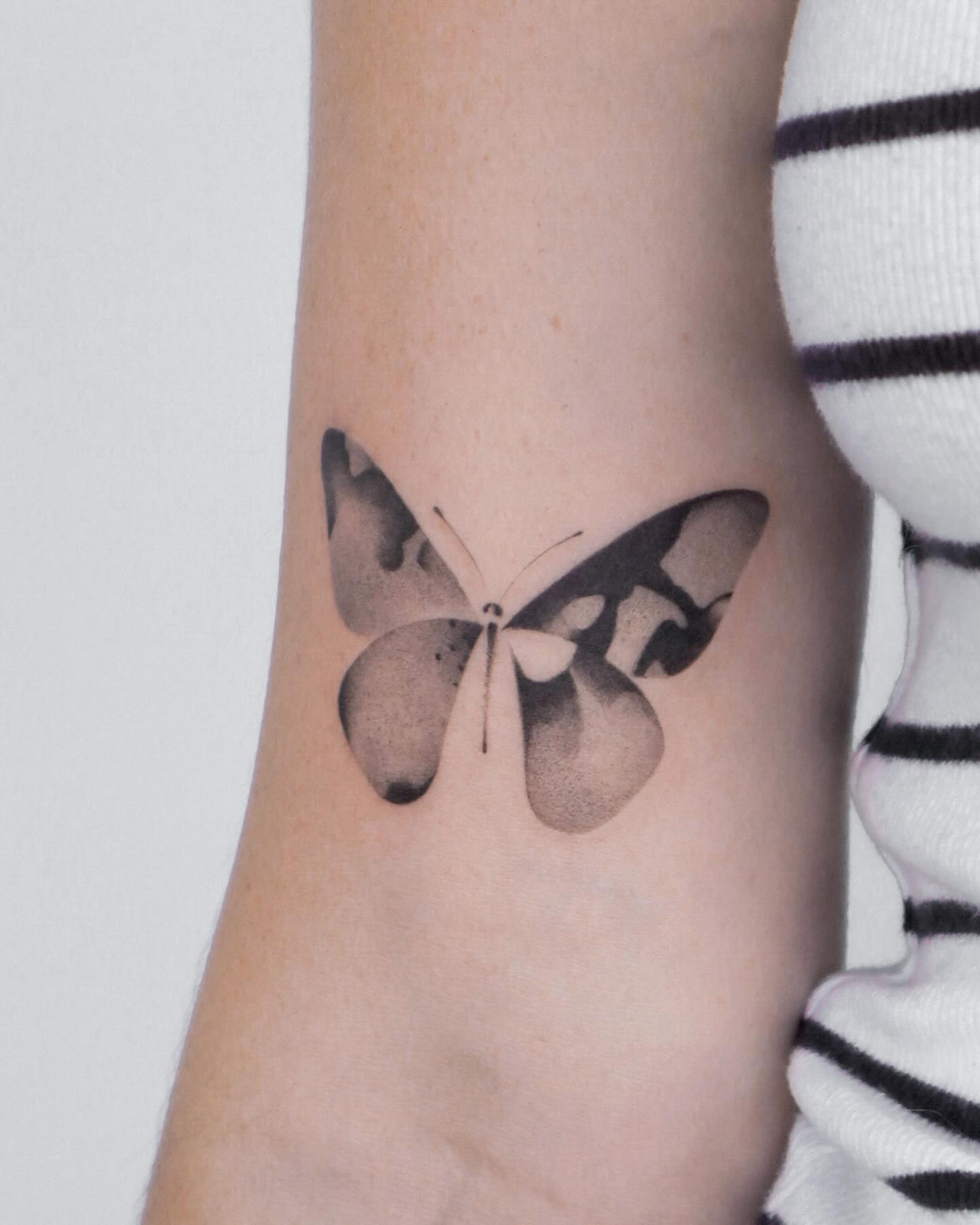 Butterfly black and grey tattoo on the forearm by River, New York, New York