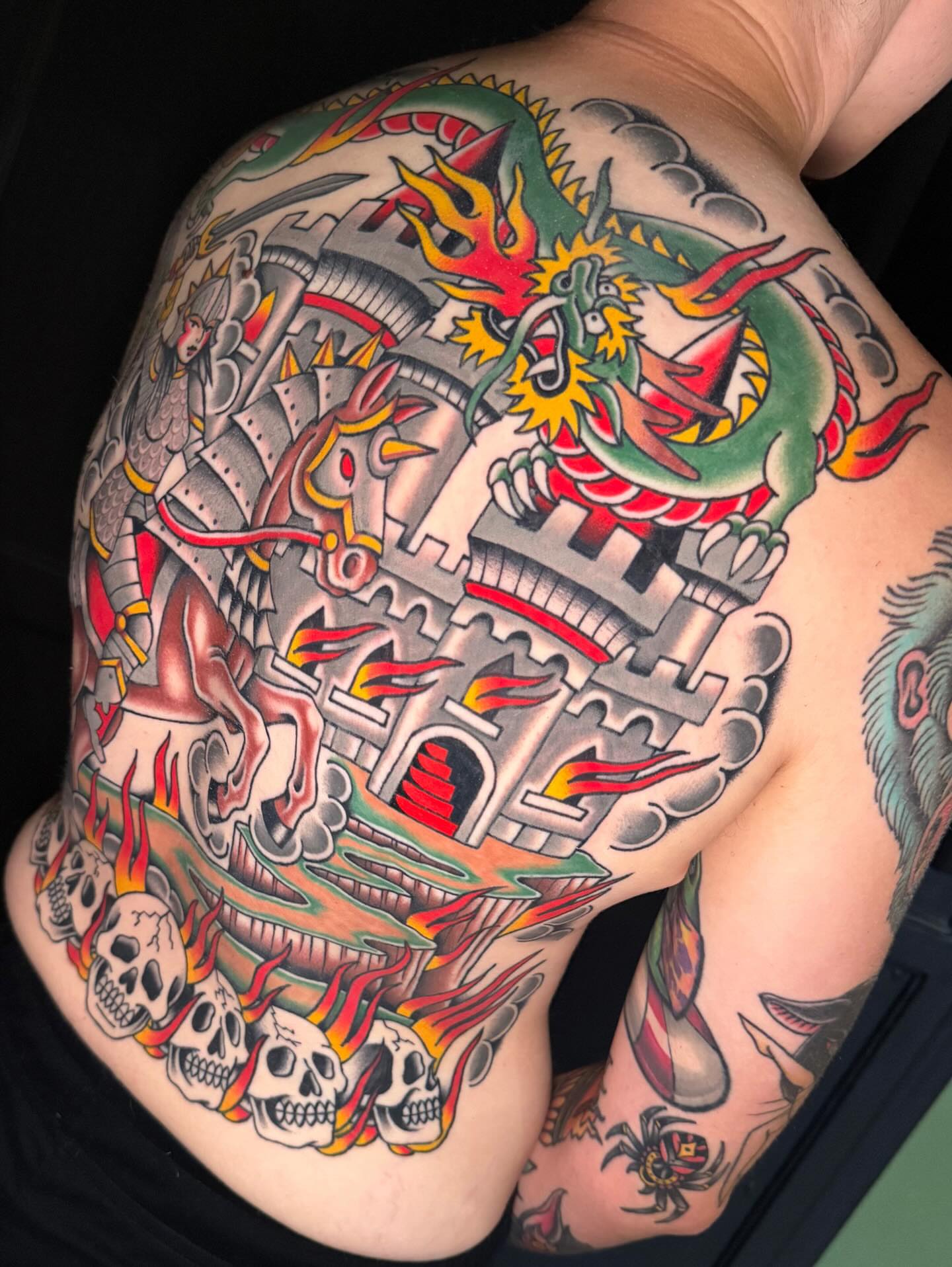 Dragon and castle American traditional tattoo on the thigh by Chelstine, Encinitas, California