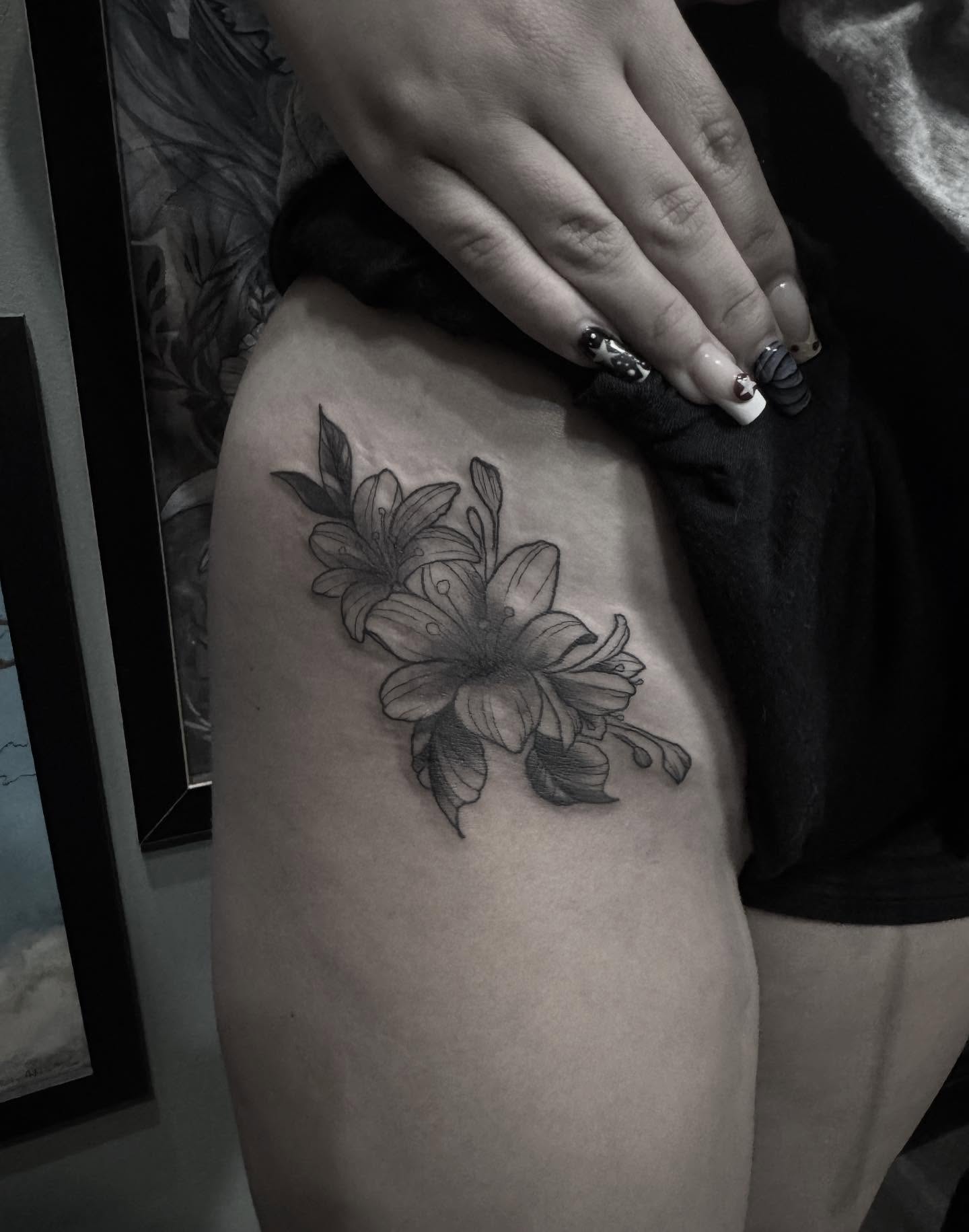 Lilies black and grey tattoo on the thigh by Joe Khay, Hackettstown, New Jersey