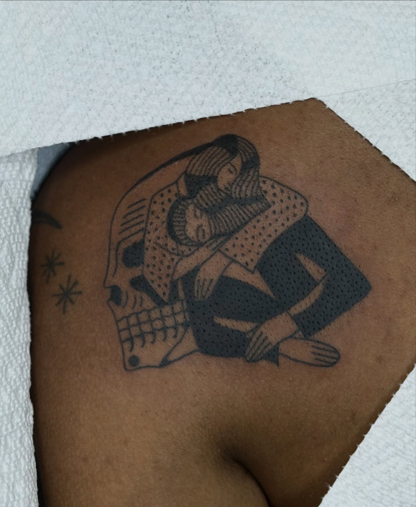 Skull and embrace dotwork tattoo on the shoulder by Maks