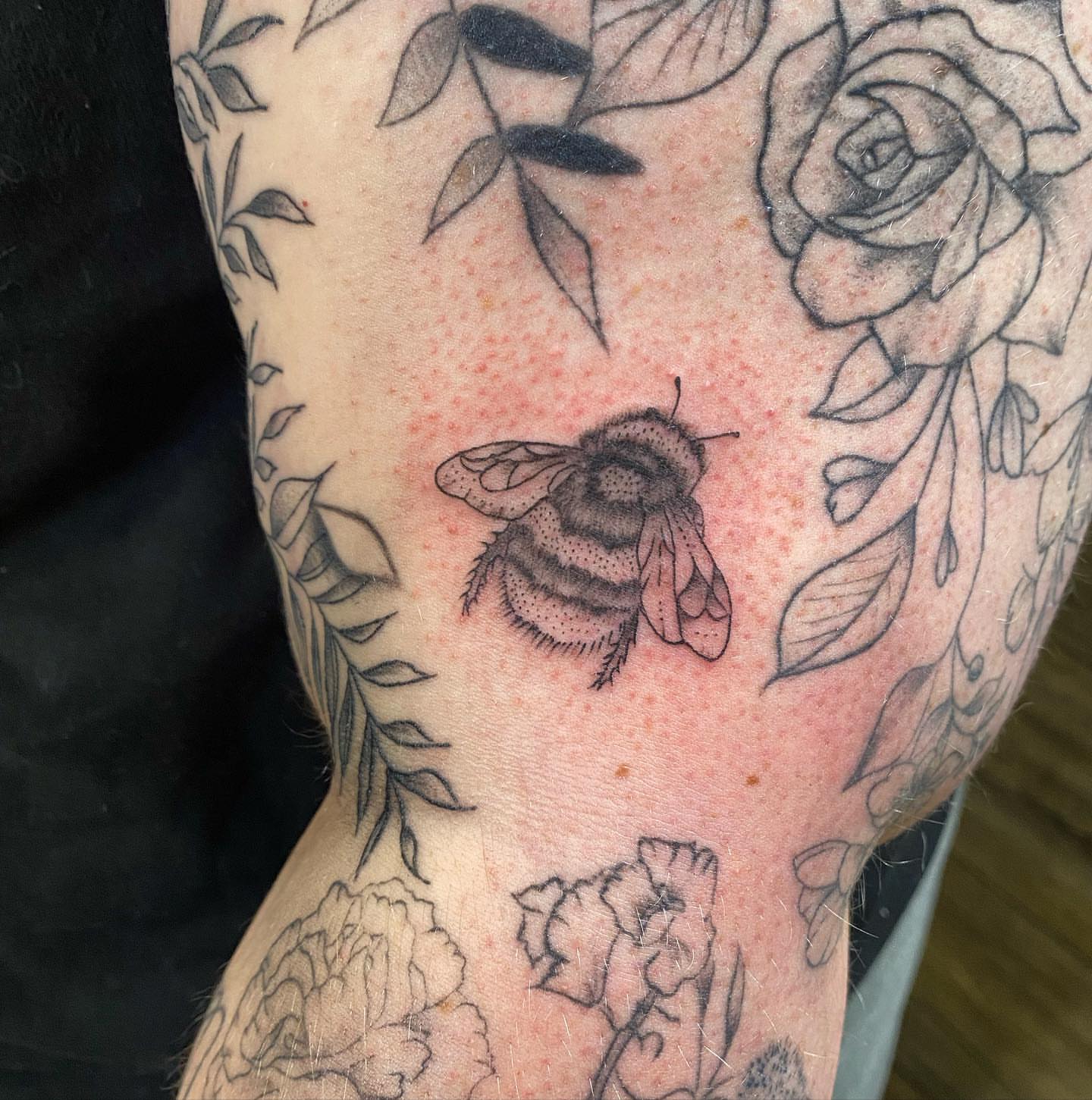 Bee black and grey tattoo on the forearm by Spencer Jones Tattoos