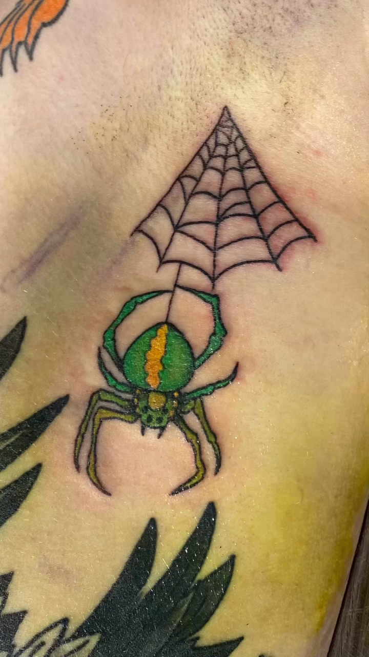 Green spider and web tattoo blackwork tattoo on the leg by jim collins, Dayton, Ohio