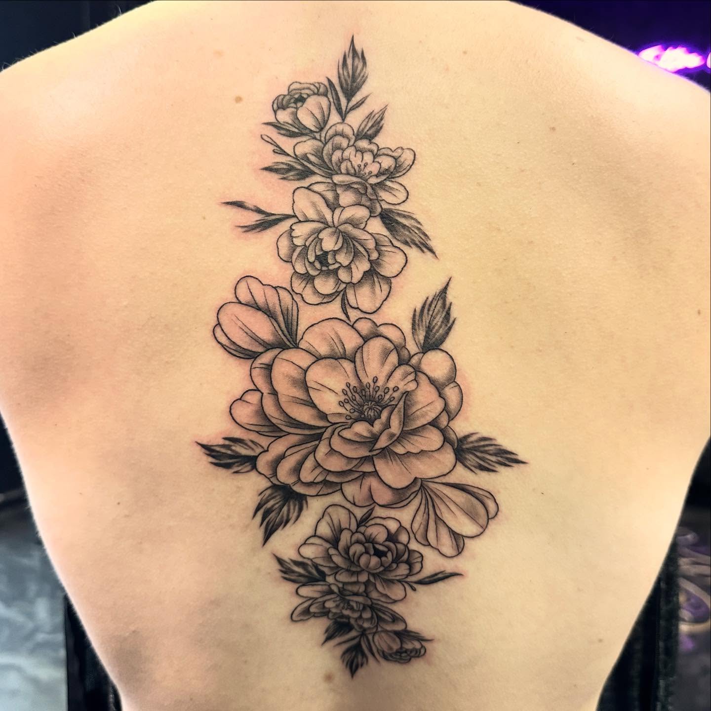 Peony flowers black and grey tattoo on the back by Sarah Nash