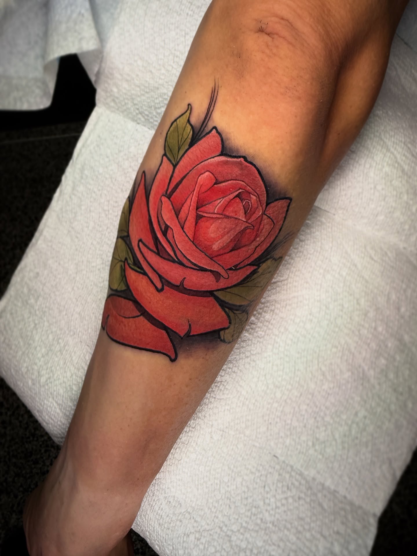 Red rose American traditional tattoo on the forearm by Neotrav Tattoos