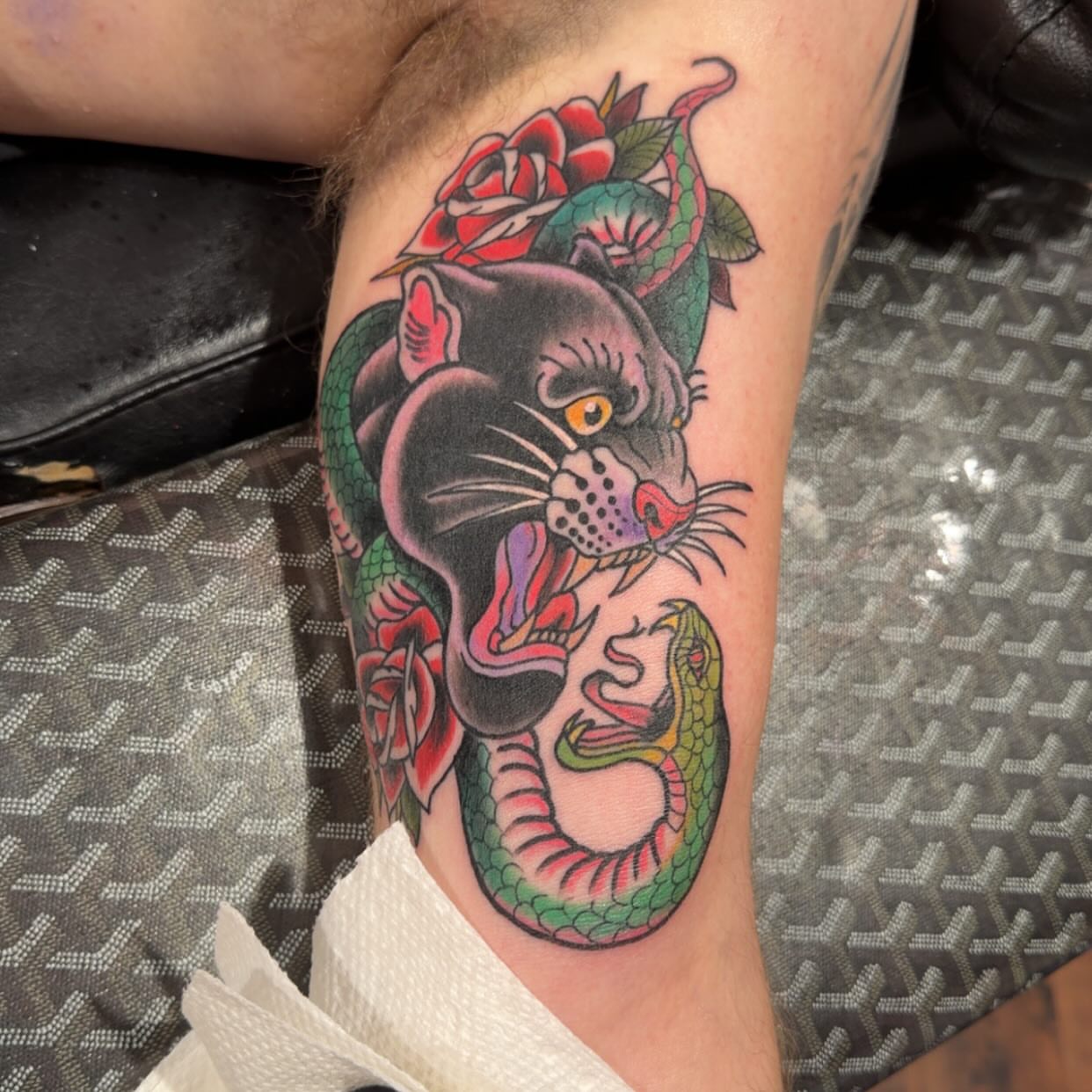 Panther and snake American traditional tattoo on the thigh by Robbie Roberson