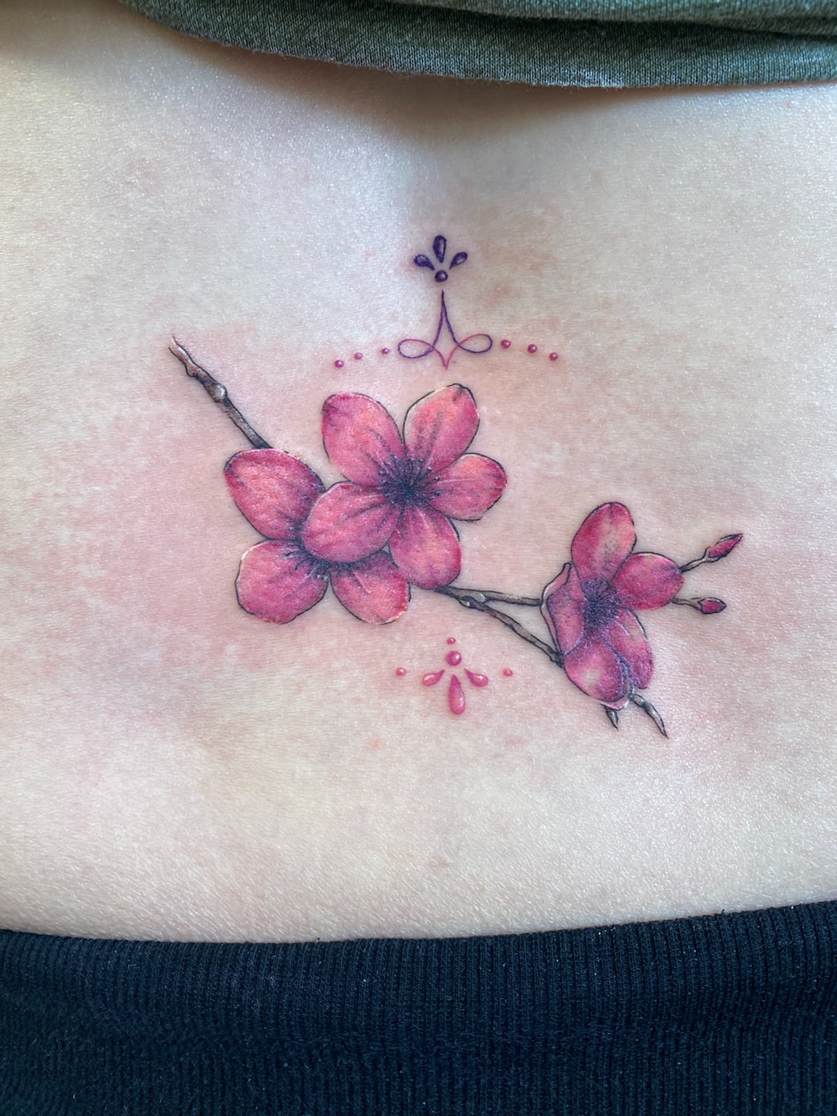 Cherry blossoms dotwork tattoo on the ribs by Ellena Reggiani