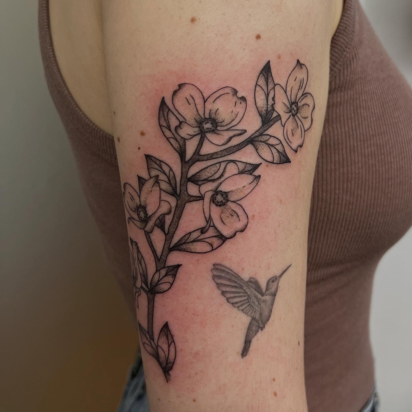 Flower branch with hummingbird black and grey tattoo on the forearm by 🍄‍🟫🍄Moth🍄🍄‍🟫