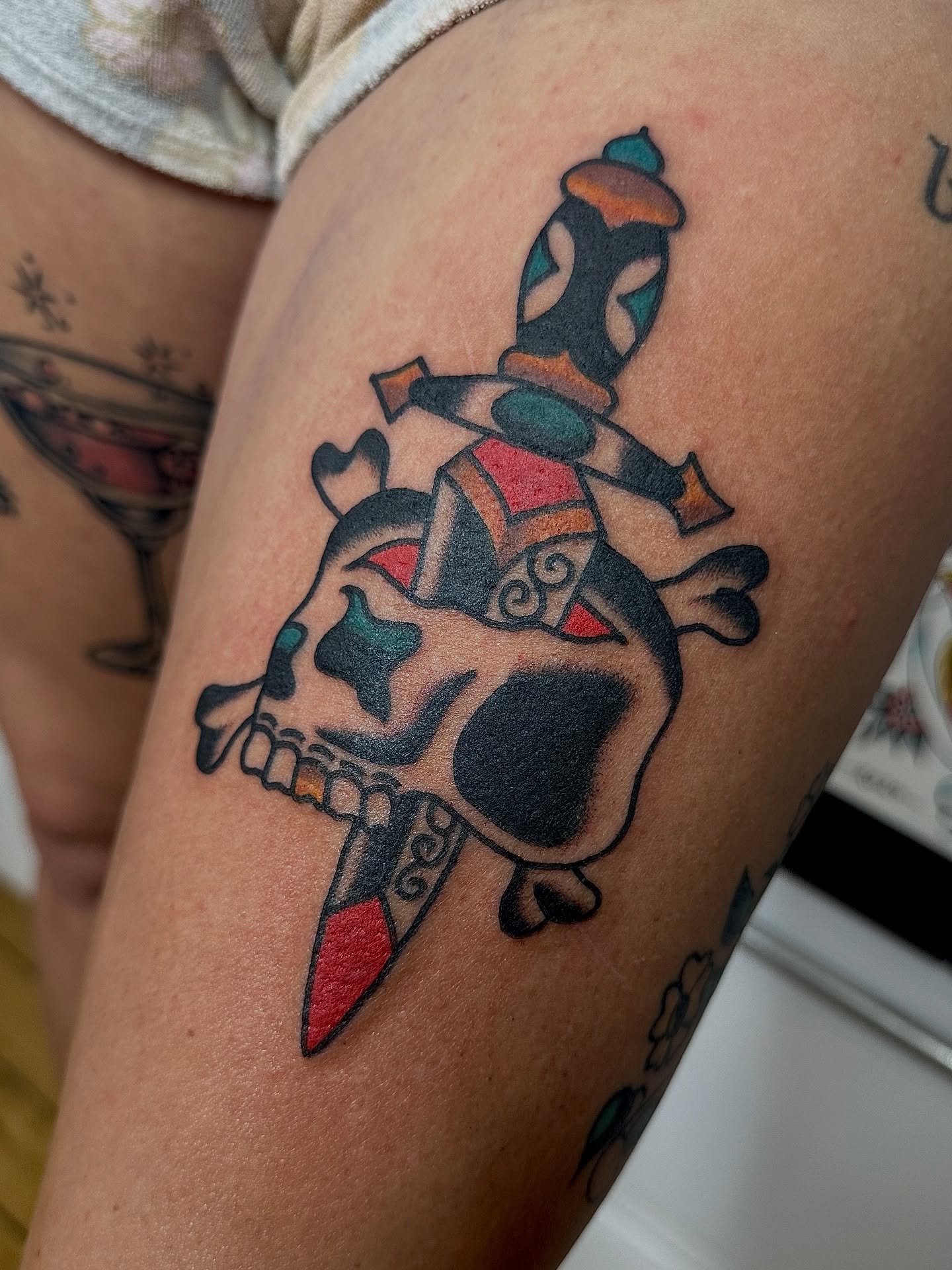 Skull and dagger American traditional tattoo on the thigh by Steven