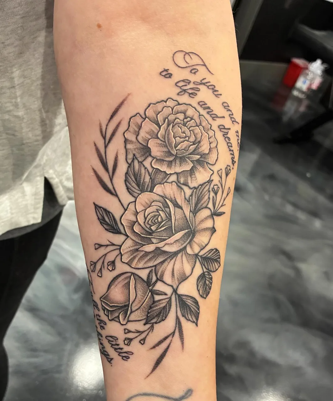 Roses and script black and grey tattoo on the forearm by Adam Silfies