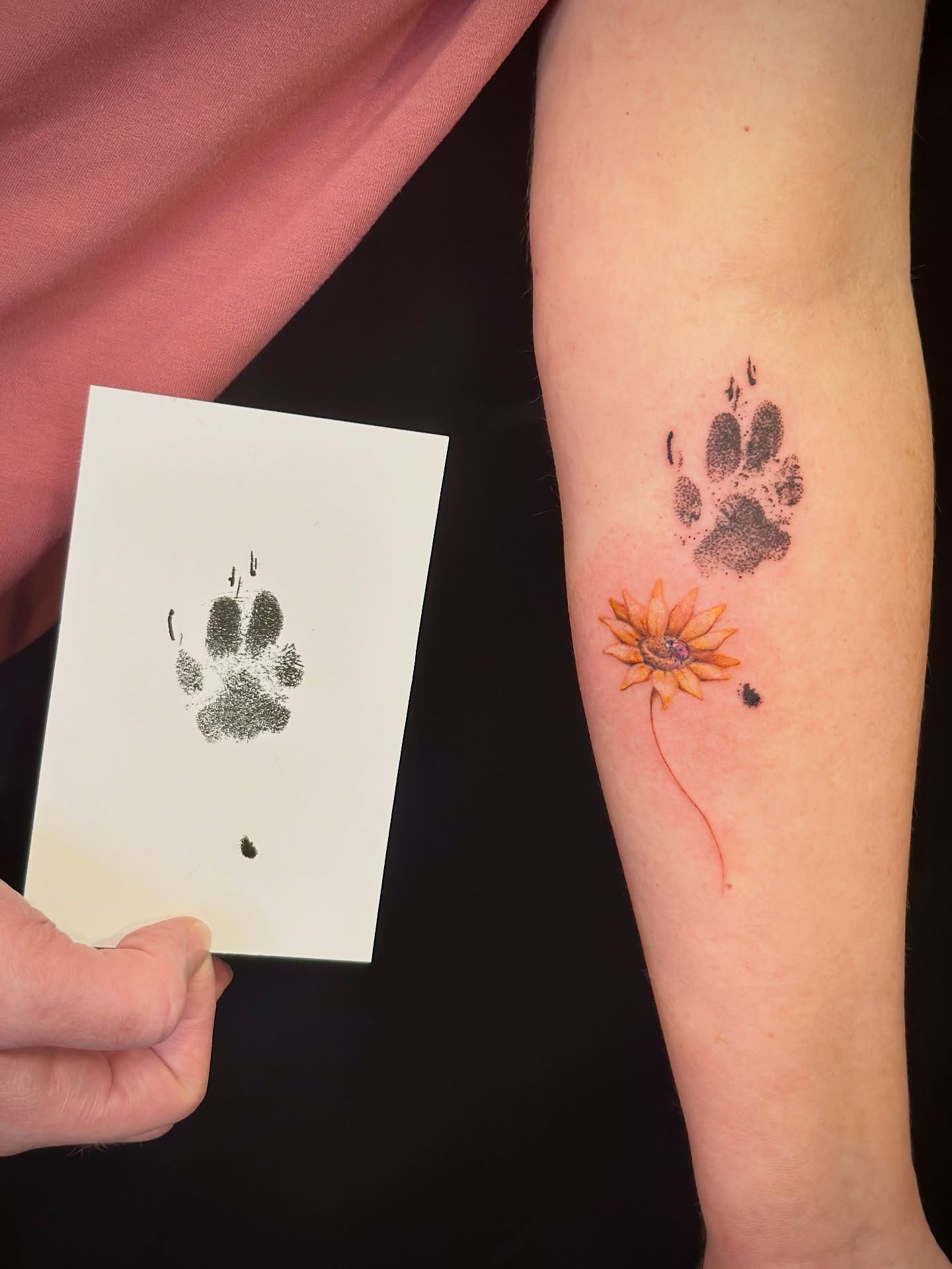 Paw print with sunflower dotwork tattoo on the forearm by Maddie Morrill