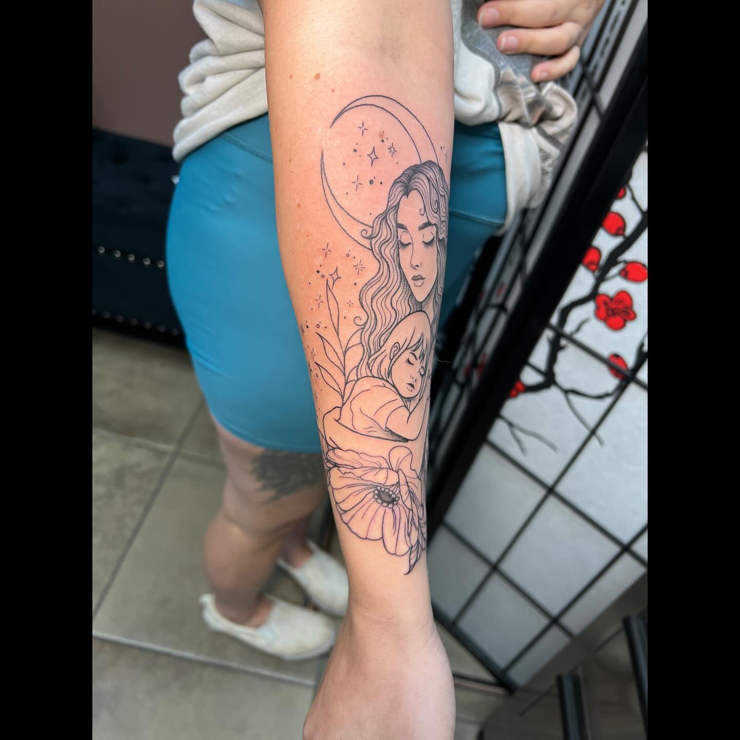 Mother and child dotwork tattoo on the forearm by Ali, Cedar Rapids, Iowa