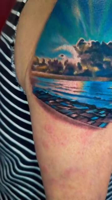 Aurora borealis over a lake realism tattoo by Michael brown