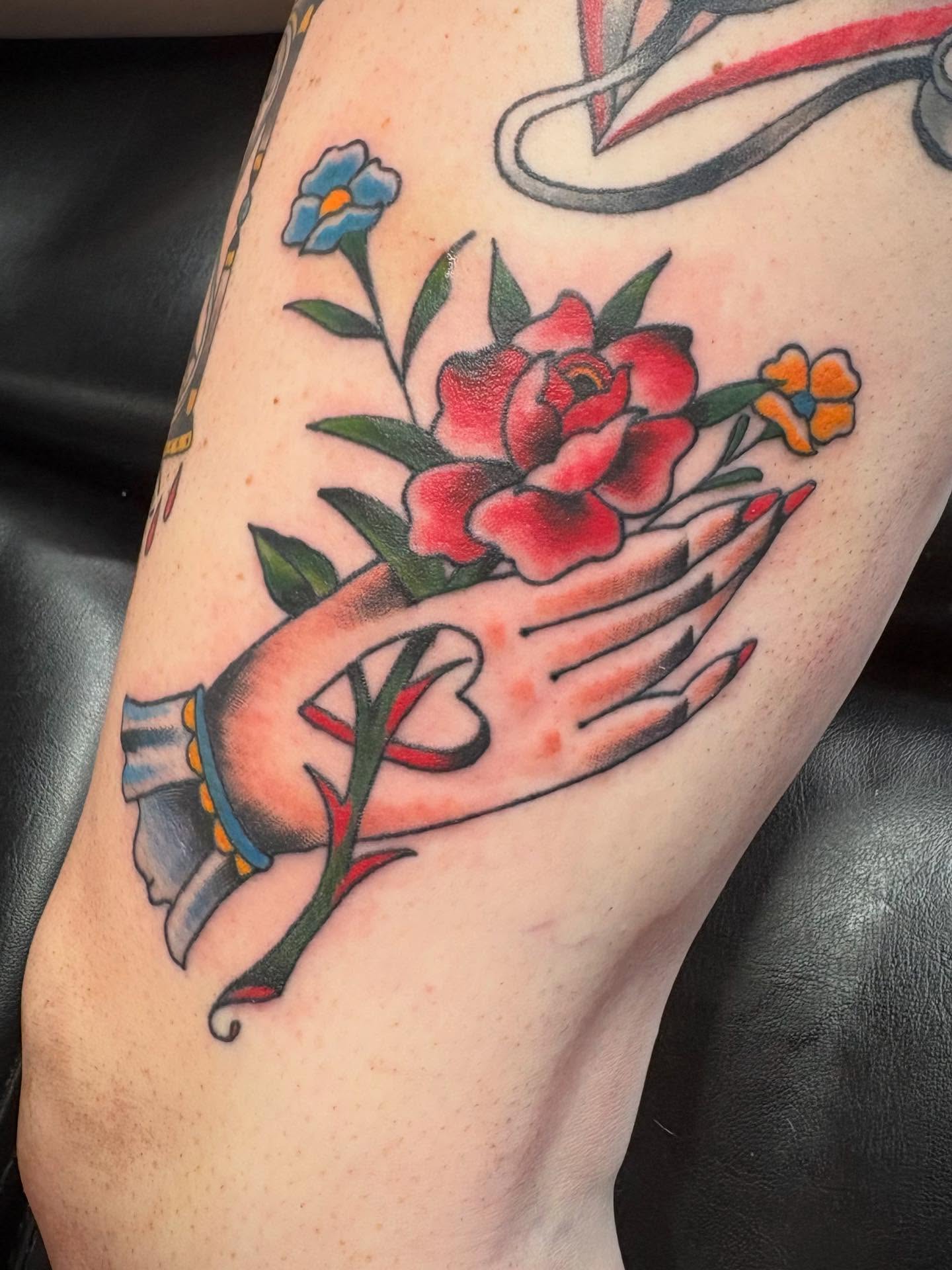 Rose and hand American traditional tattoo on the forearm by Robbie Reel, Wichita, Kansas