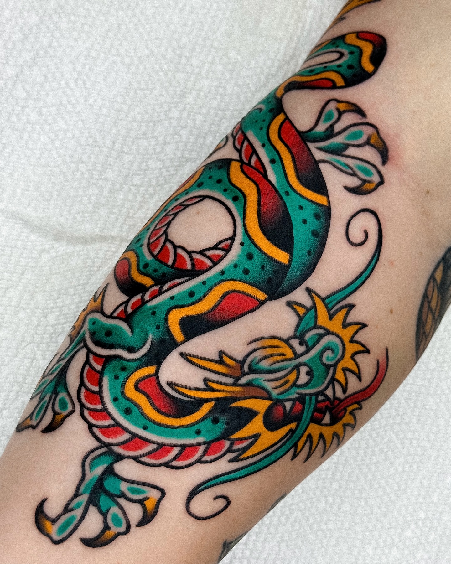 Dragon American traditional tattoo on the forearm by Samuel Dickey