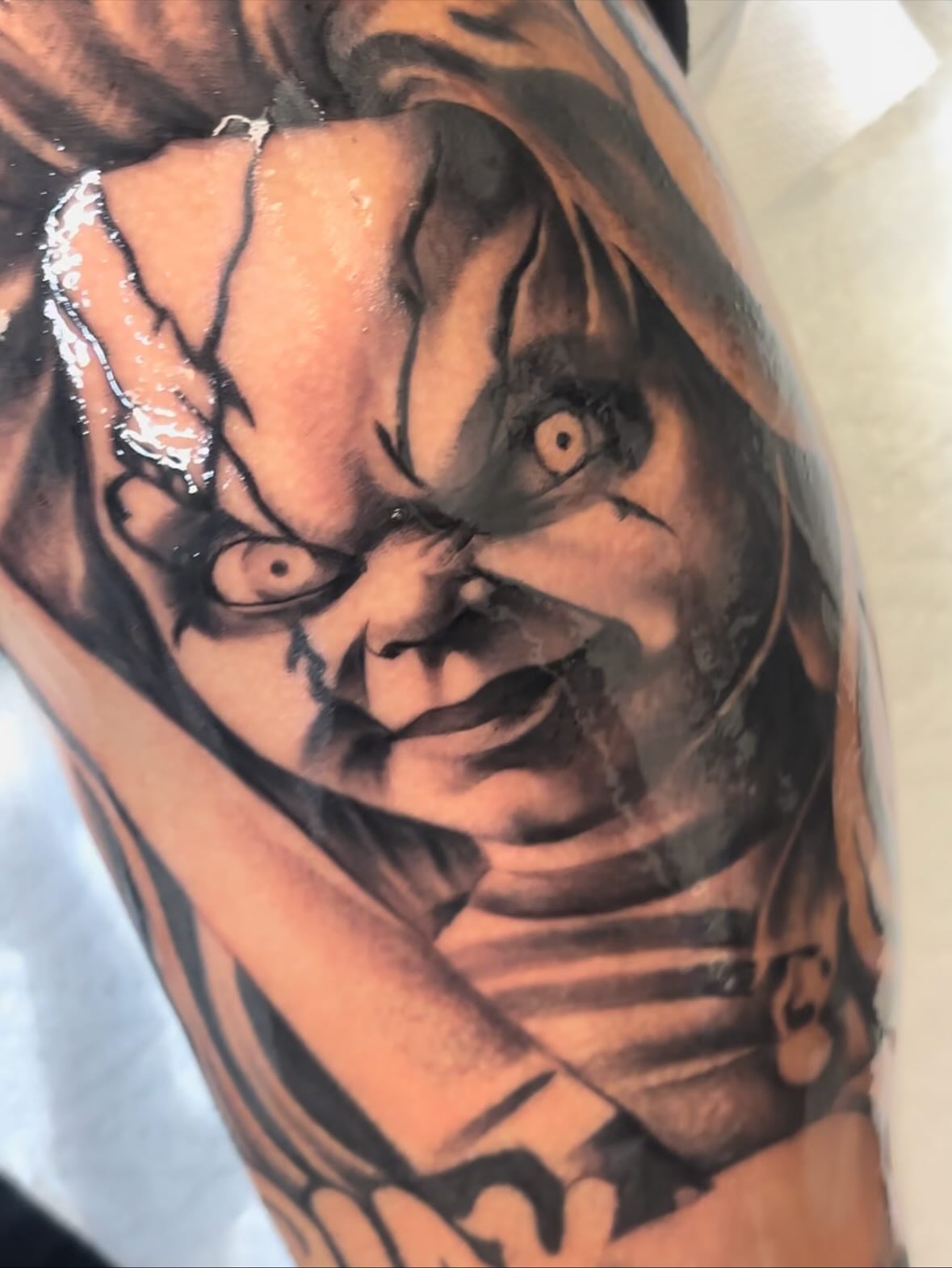 Chucky realism tattoo on the forearm by FleeDott 🇨🇴