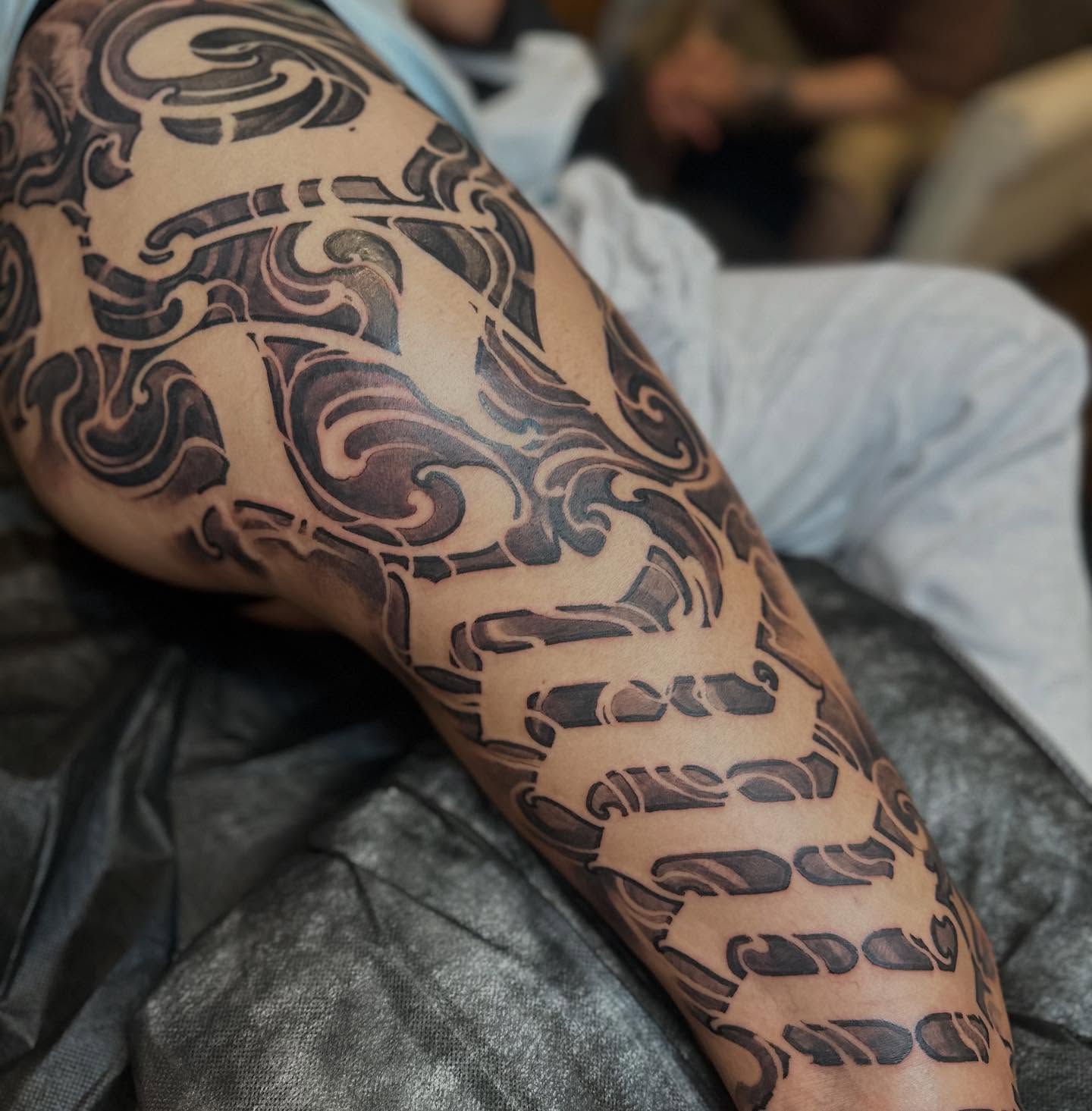 Scrollwork black and grey tattoo on the forearm by Tattoos By Deft