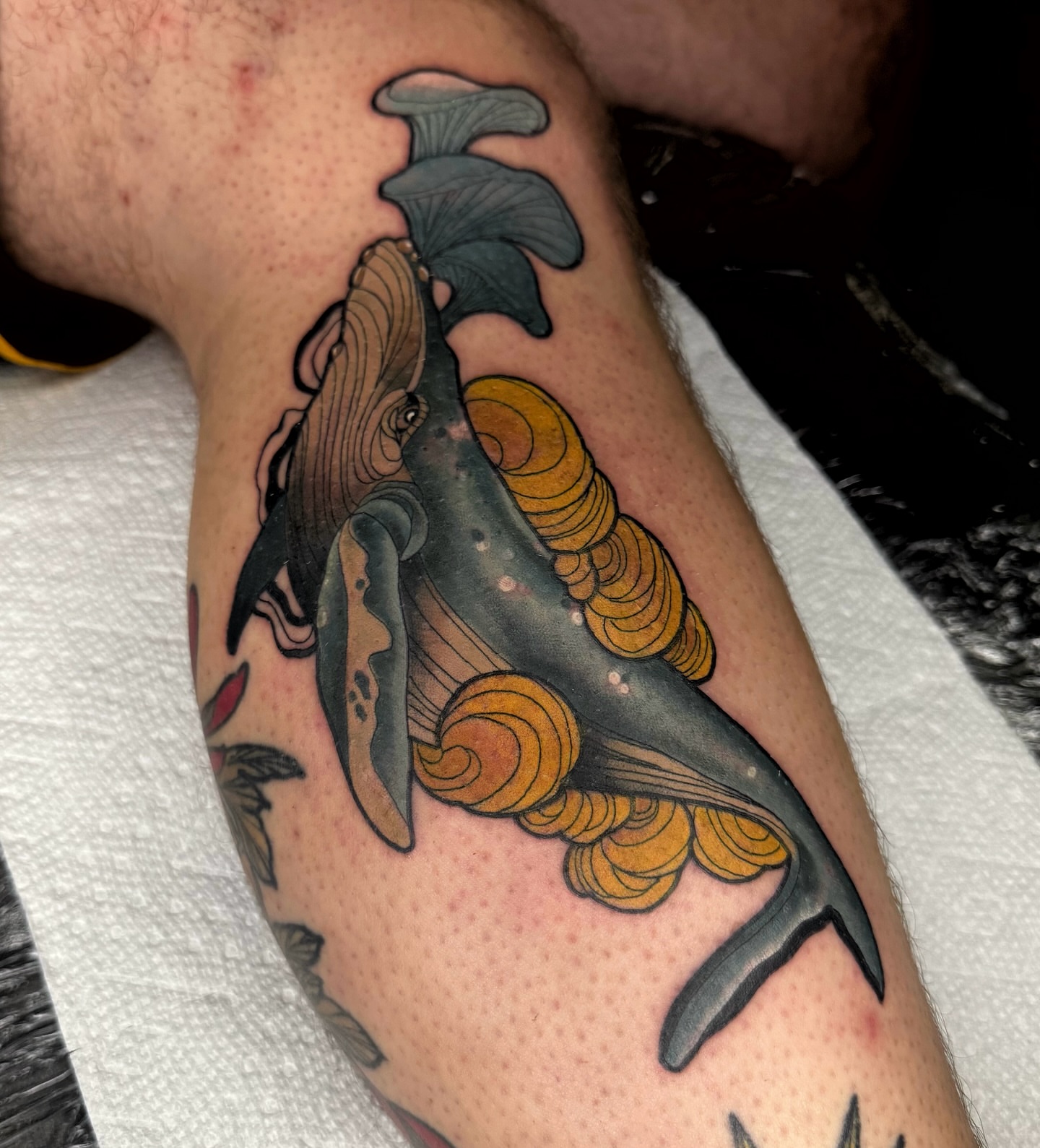 Whale and waves American traditional tattoo on the forearm by Brett Brown