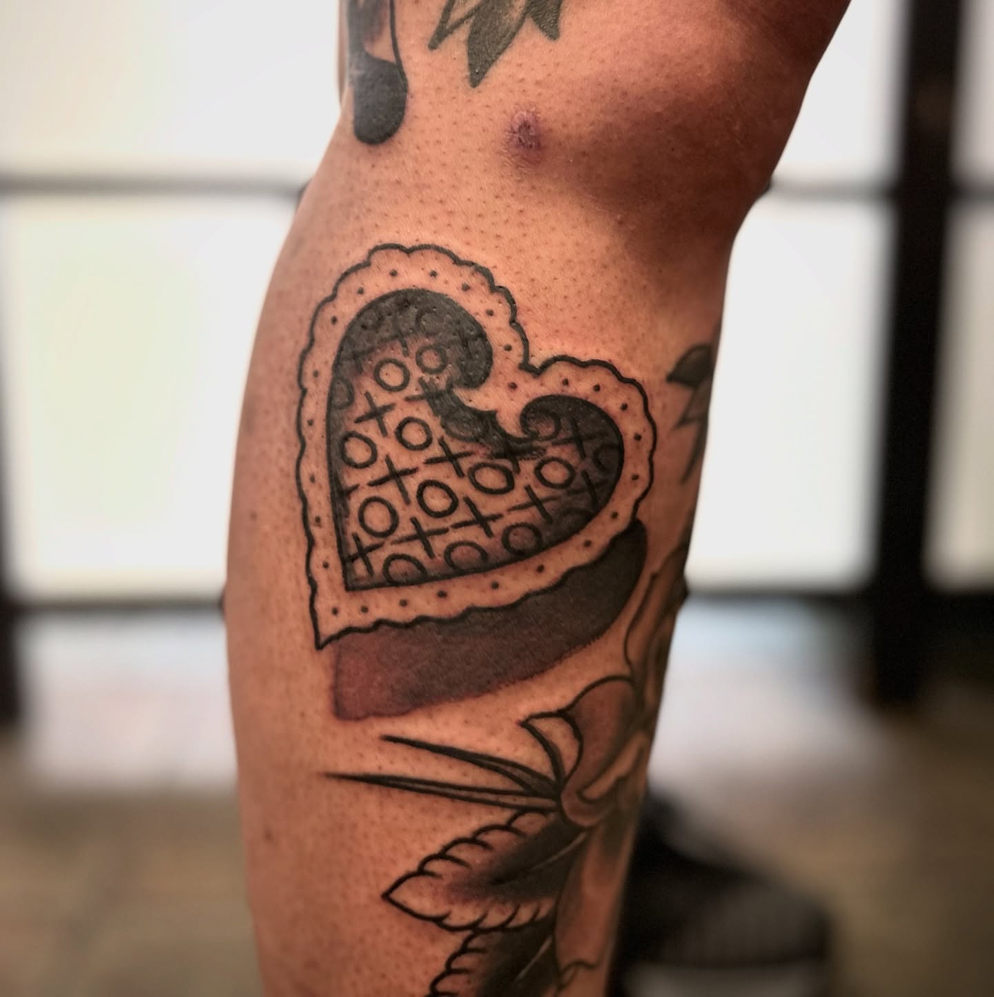 Tic-tac-toe heart dotwork tattoo on the forearm by Ryan Willard, Denver, Colorado