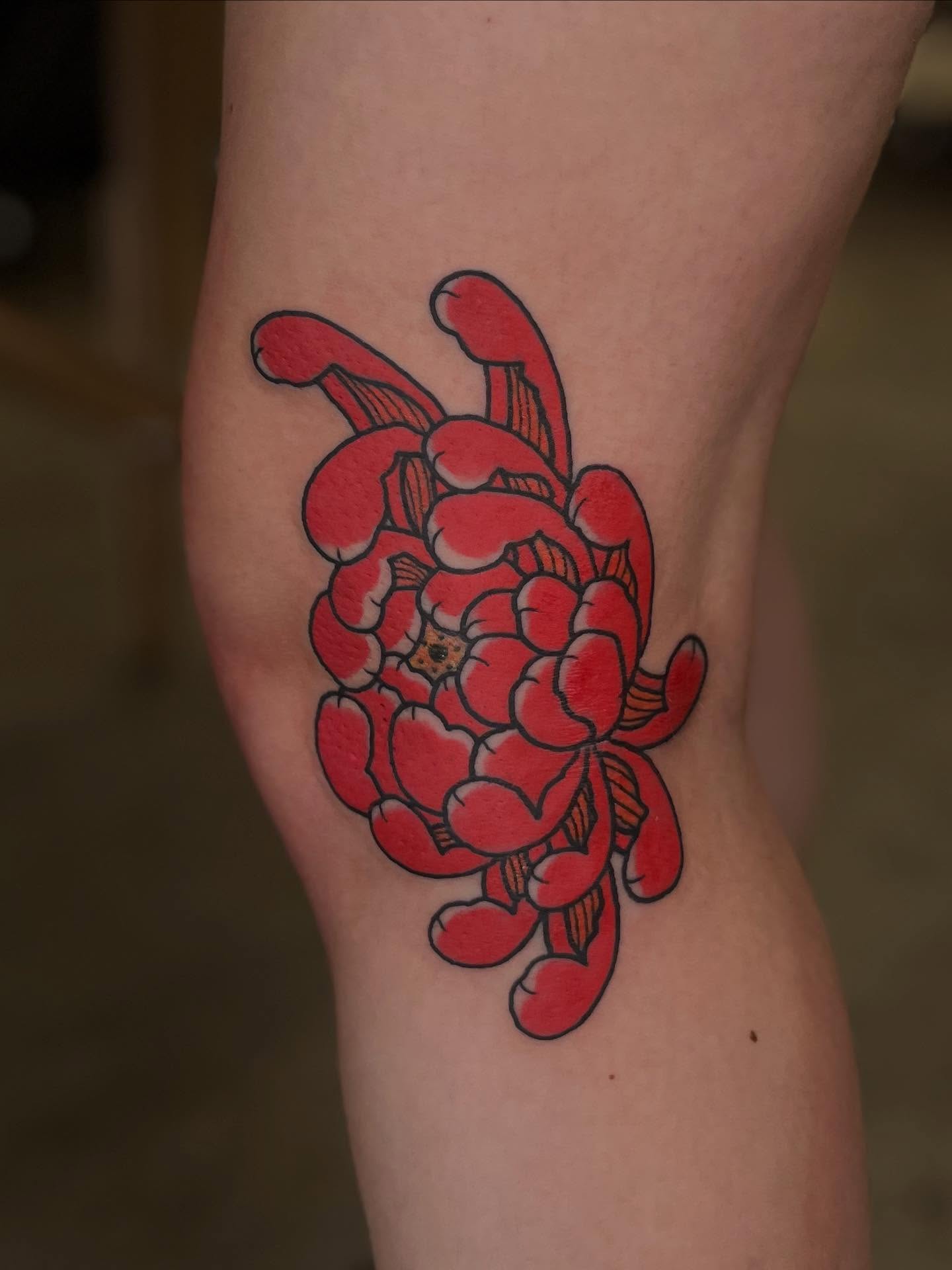Chrysanthemum American traditional tattoo on the thigh by Kaichi Fujita, Eugene, Oregon