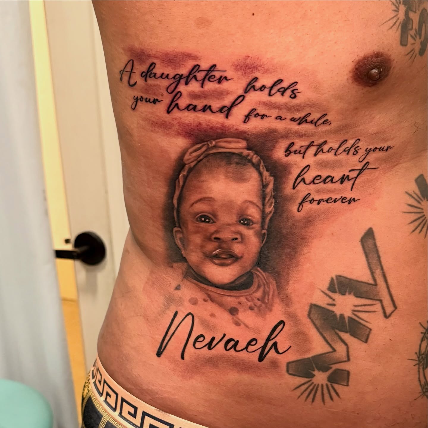 Child portrait realism tattoo on the ribs by Tatum