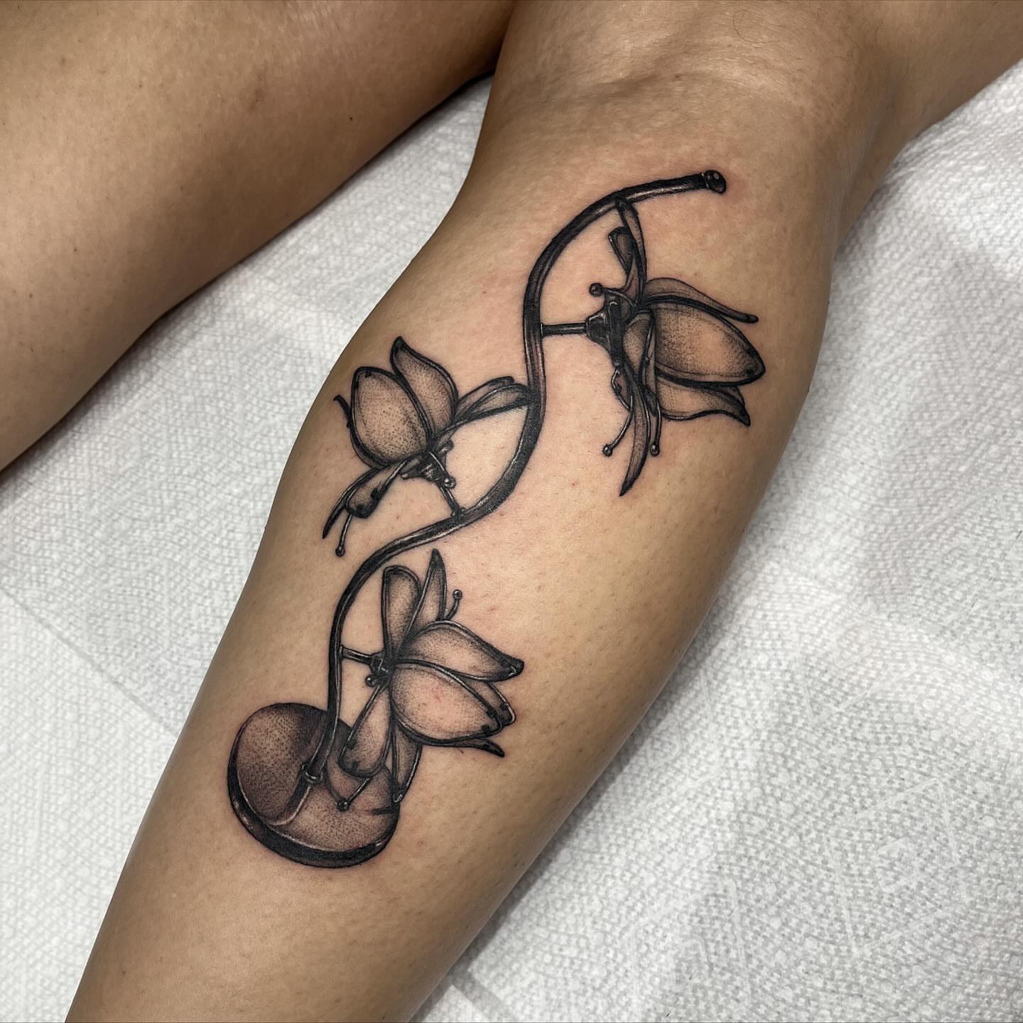 Music notes and flowers dotwork tattoo on the forearm by aurora