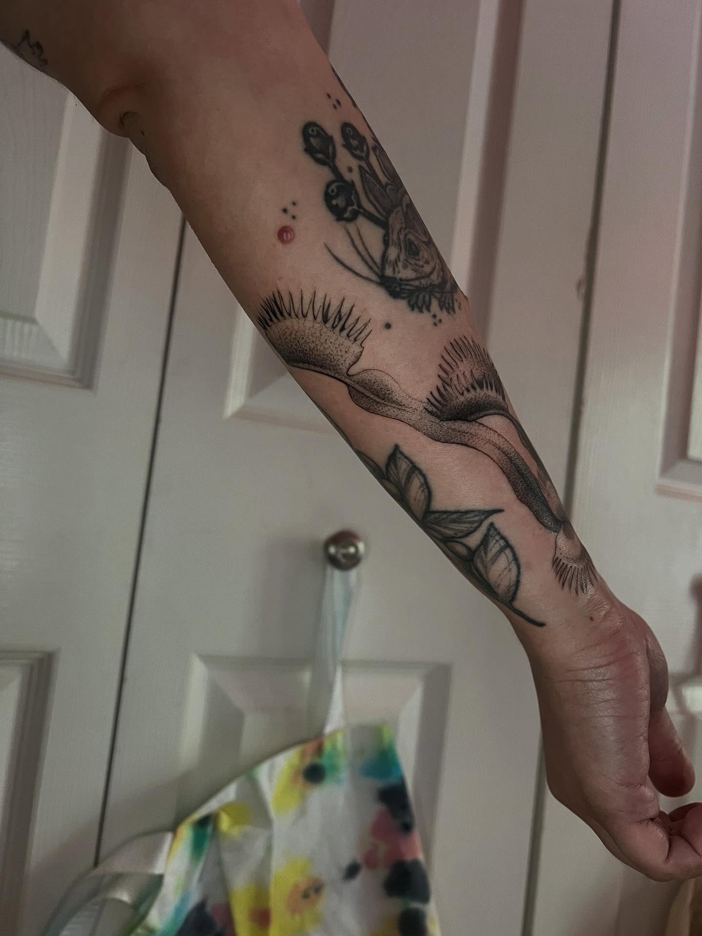 Flower and rabbit dotwork tattoo on the forearm by Natasha