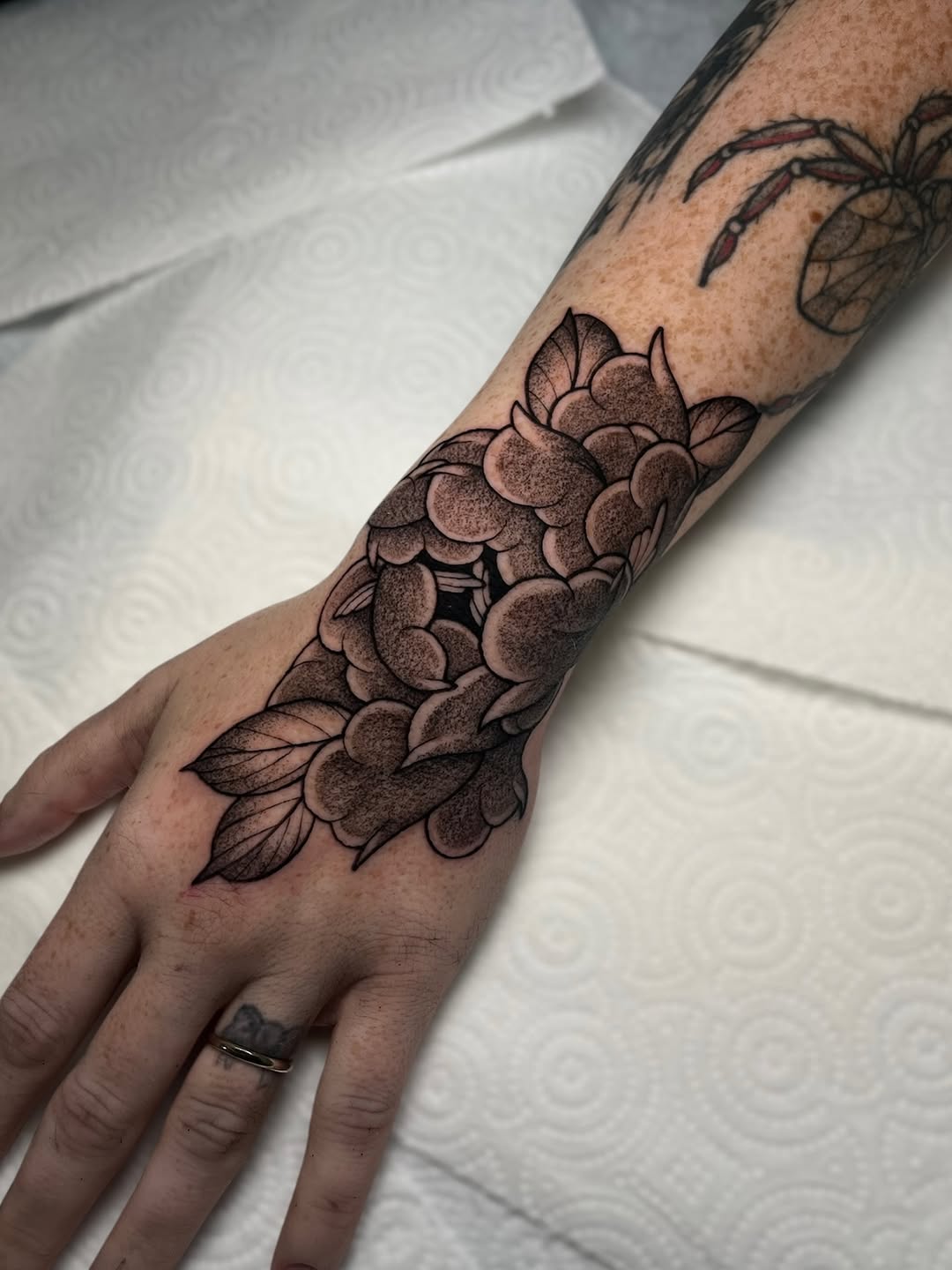 Chrysanthemum flower dotwork tattoo on the forearm by Bee π