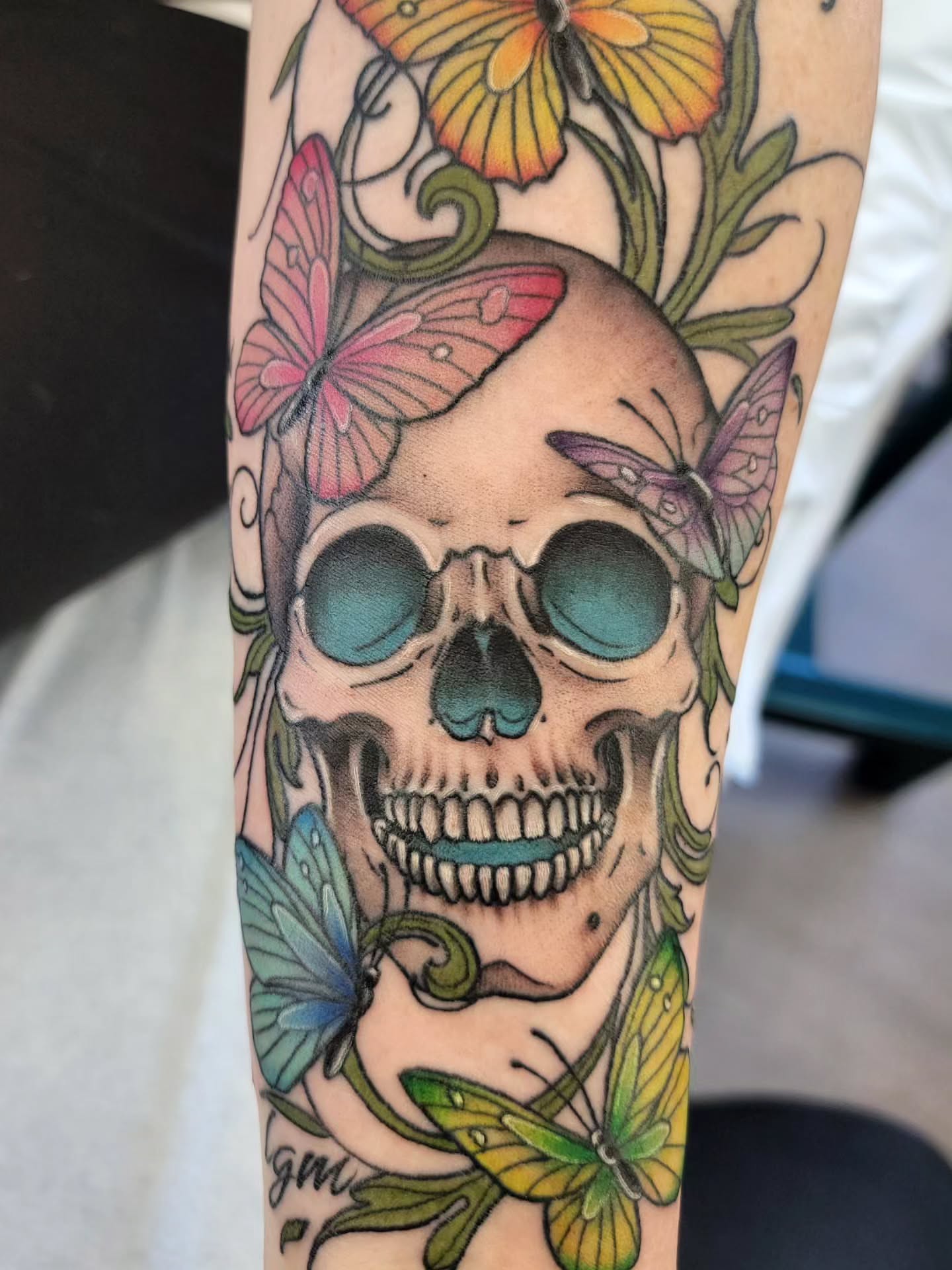 Skull with butterflies realism tattoo on the forearm by Chantel Chan, Portland, Oregon