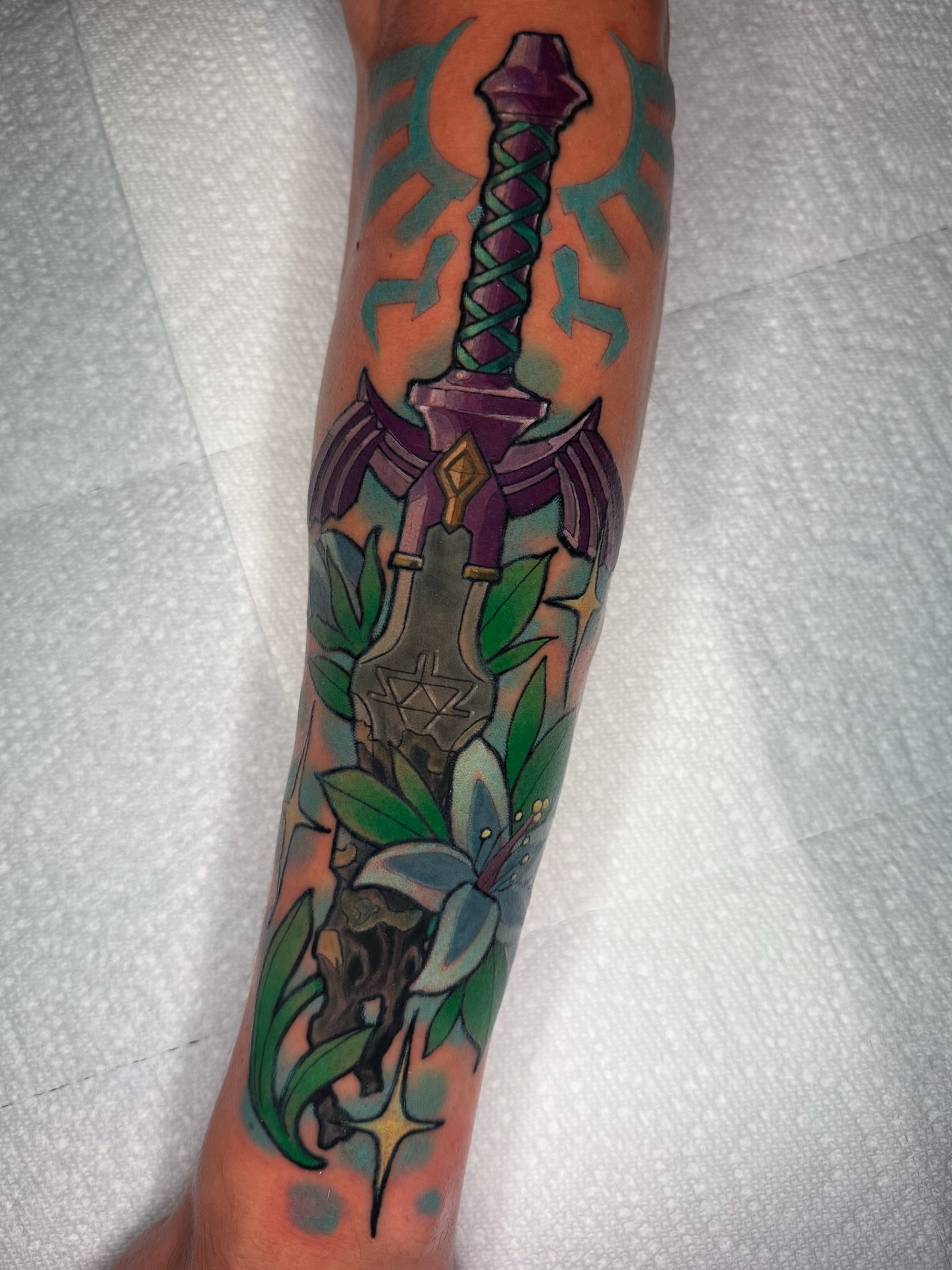 Sword and lily American traditional tattoo on the forearm by Austin Britt